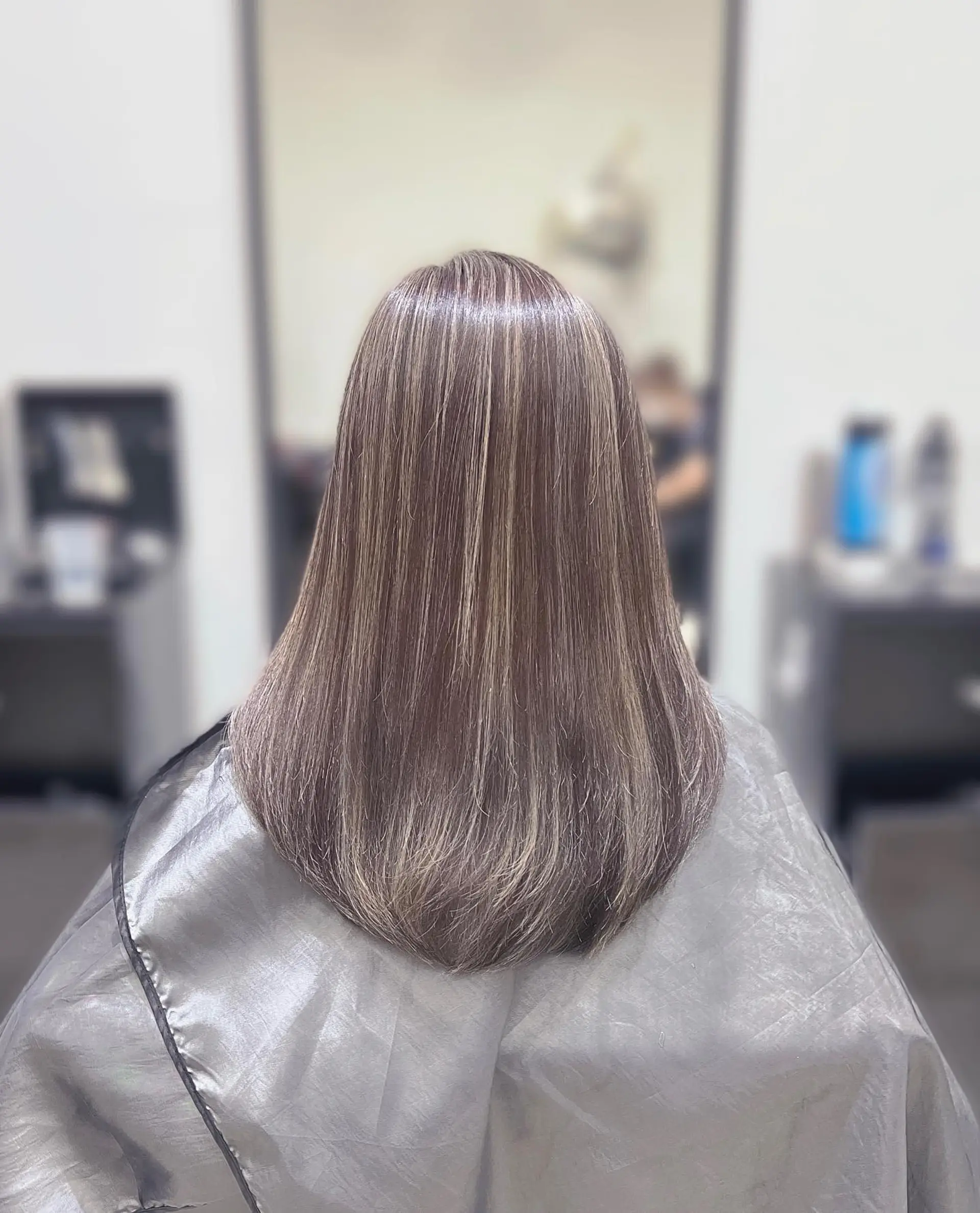 Long straight hairstyle with subtle ash blonde balayage highlights. 1