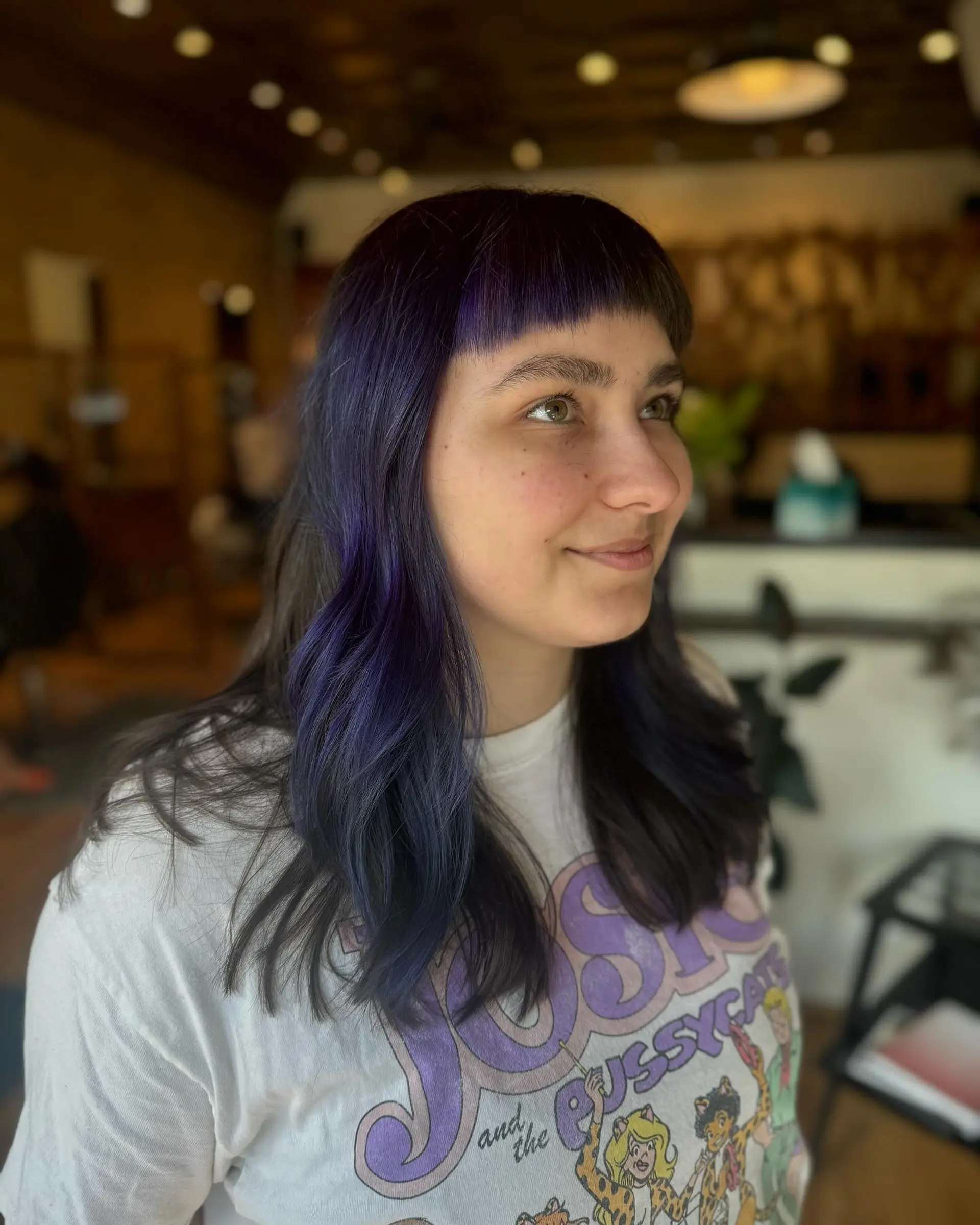 Long, straight hair with short blunt bangs, featuring an indigo and purple color melt. 2