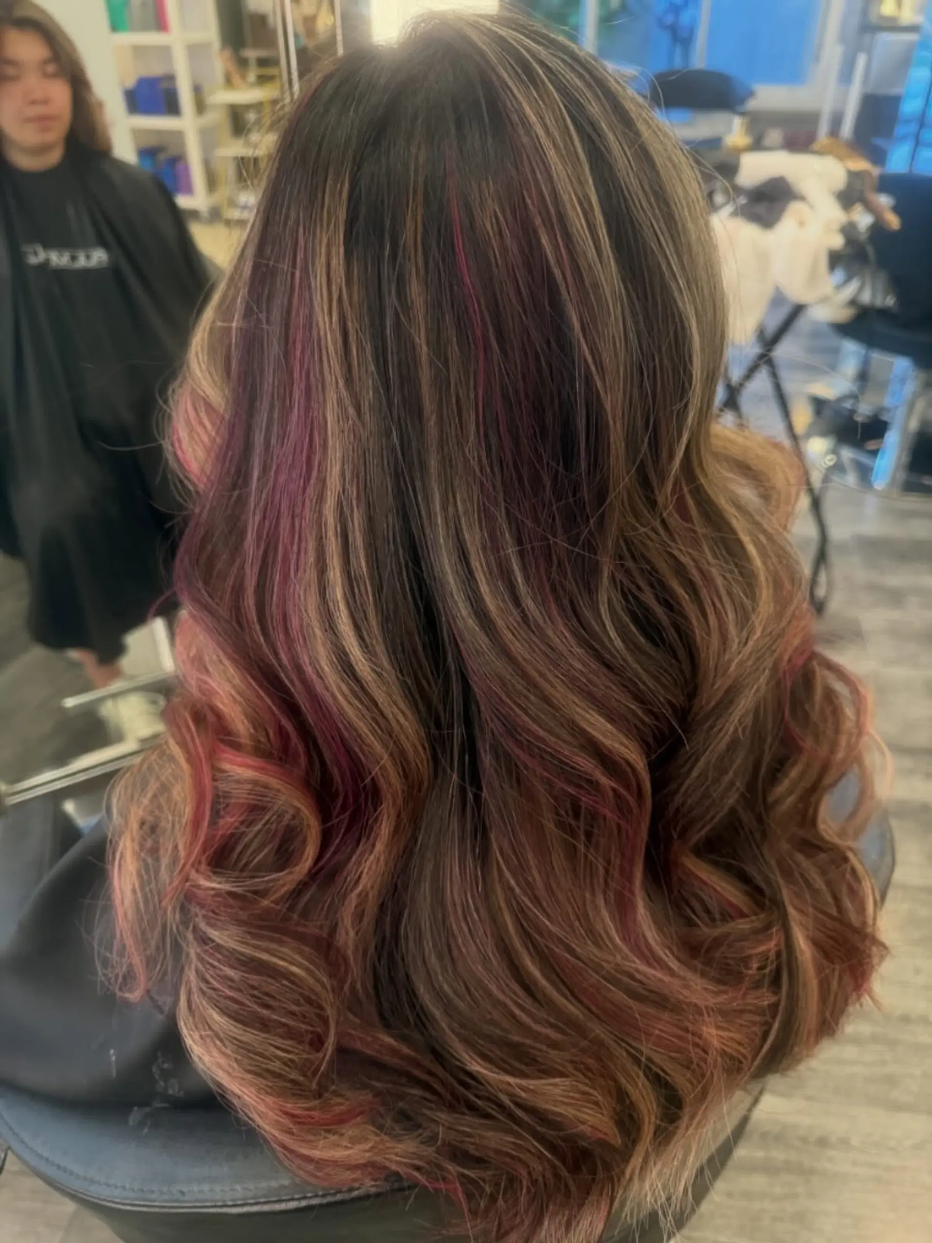 Long cascading waves featuring a rich brunette base woven with warm caramel and vivid magenta-pink highlights. 1