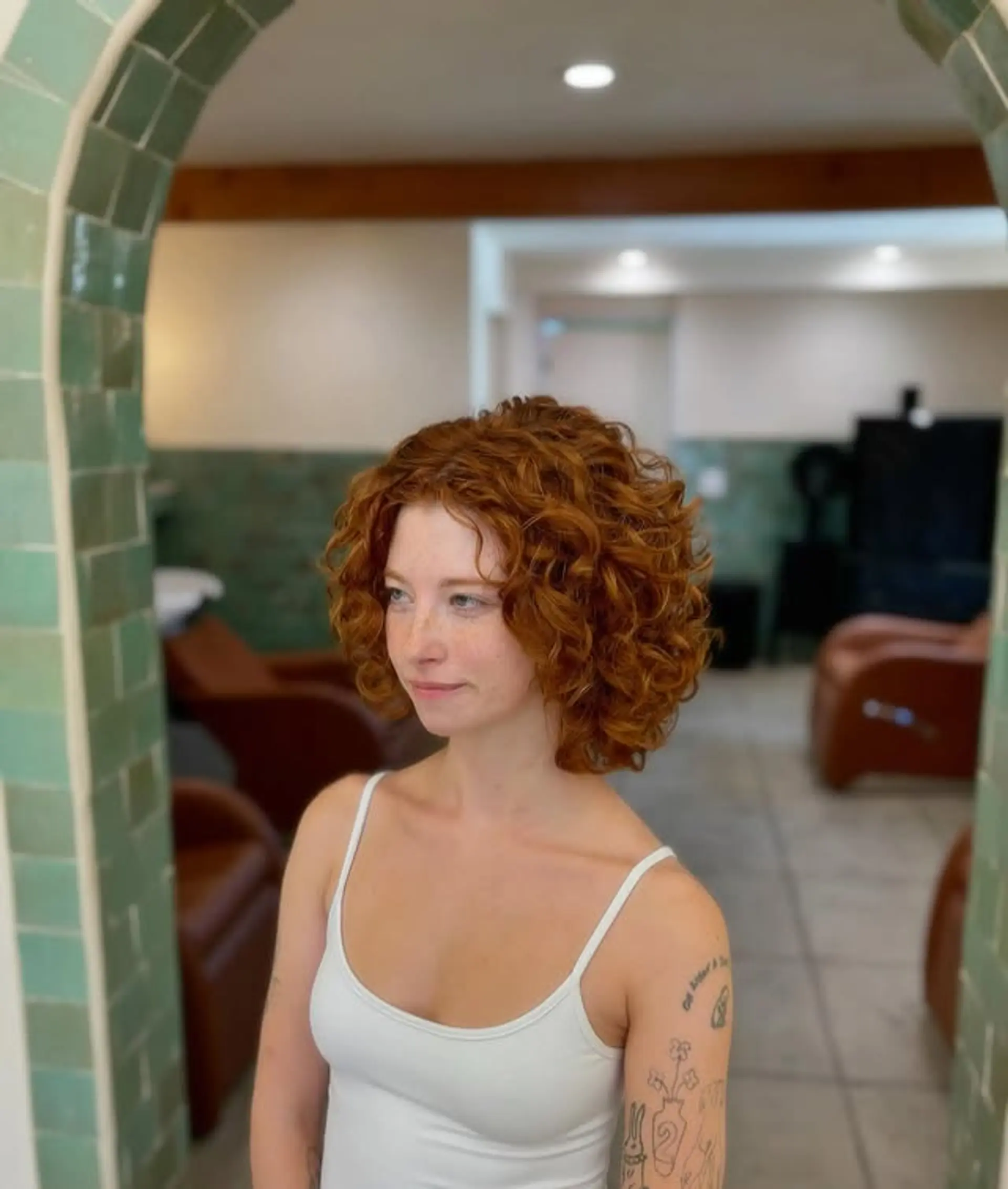 A medium-length curly bob with lots of volume and a rounded shape. 1