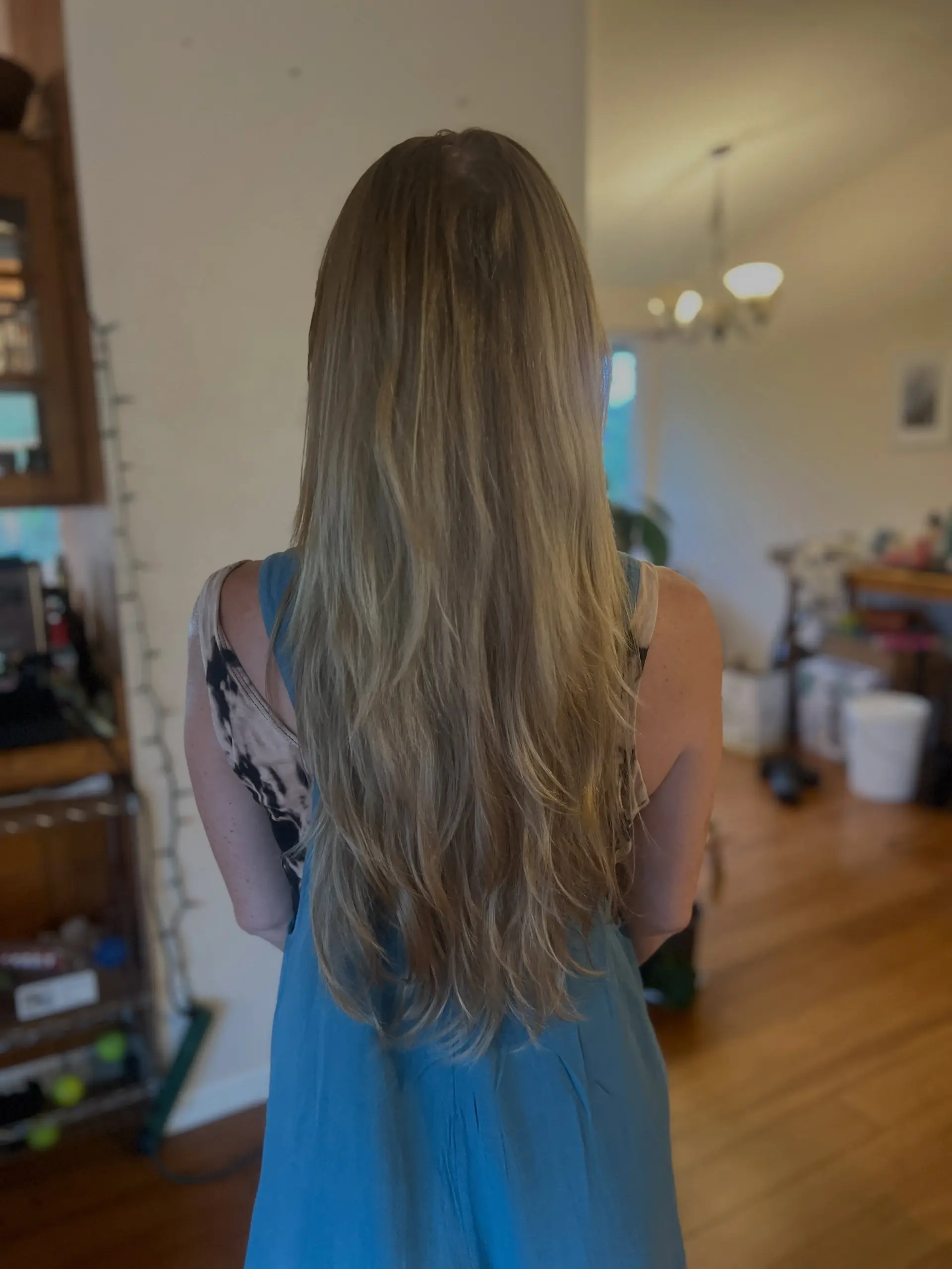 Extra-long natural blonde hair featuring blended, flowy layers that provide movement and texture to the ends. 1