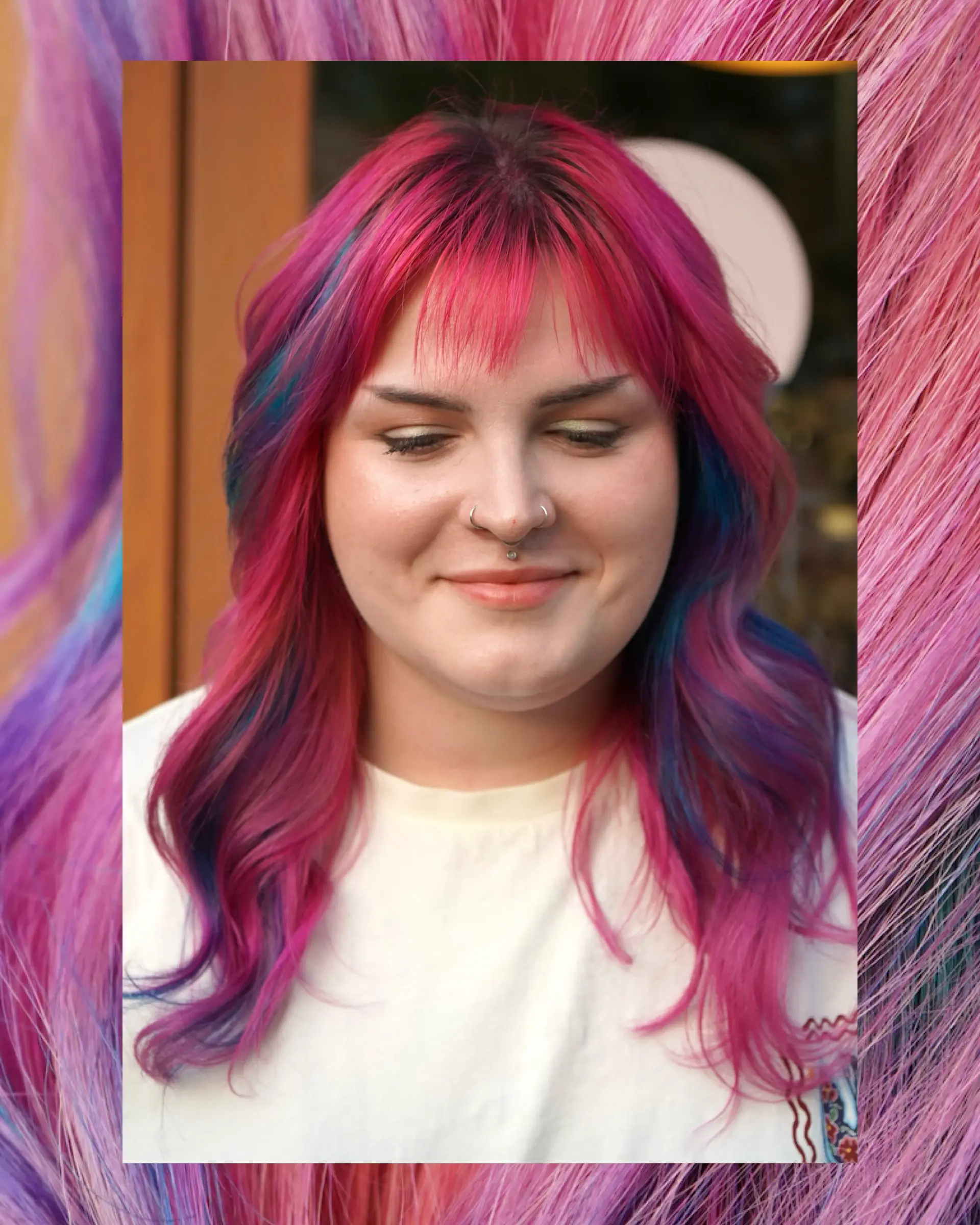 A vibrant layered shag with wispy fringe featuring hot pink hair accented with blue and purple highlights. 1
