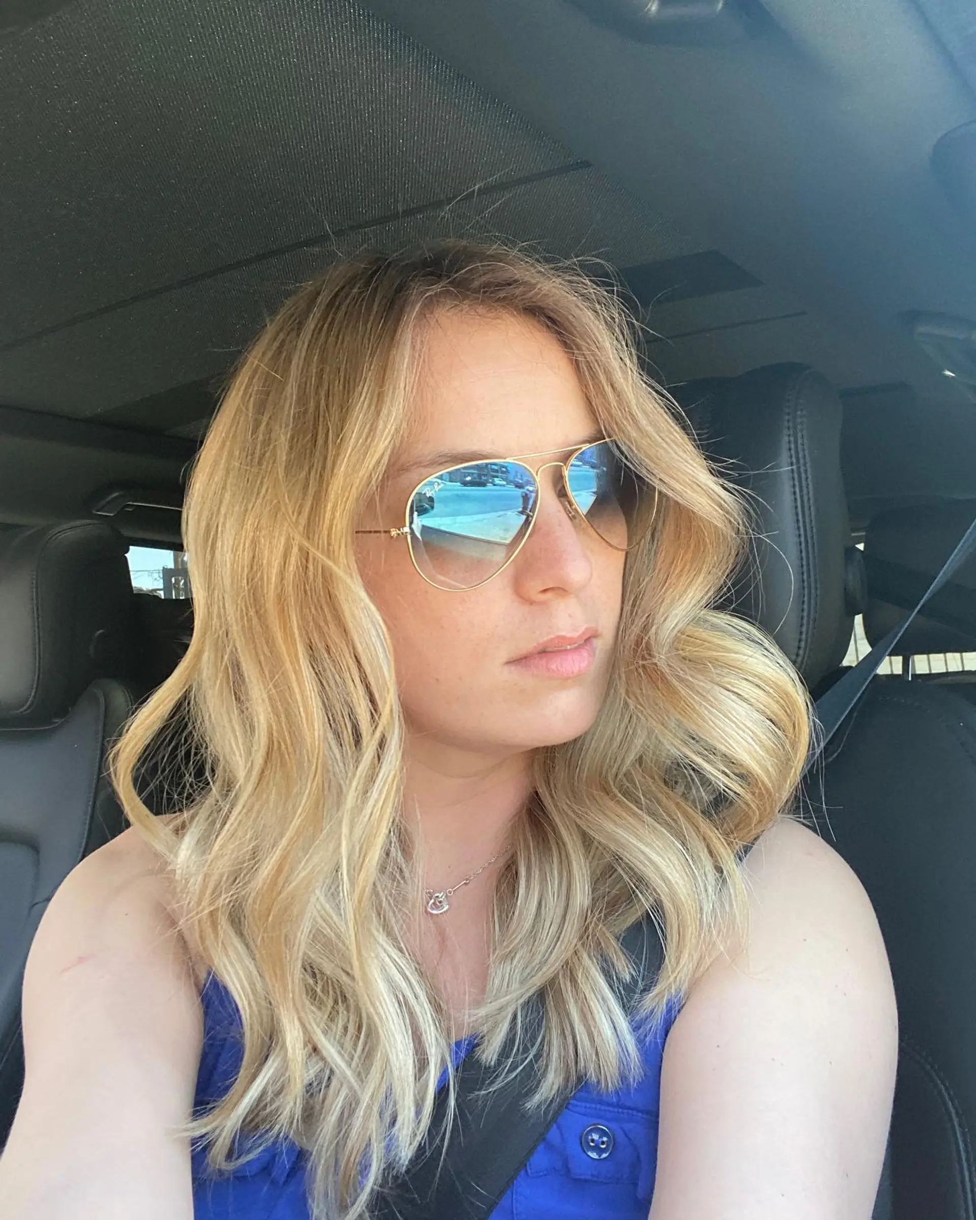 Dimensional blonde balayage styled with loose, flowing waves. 1