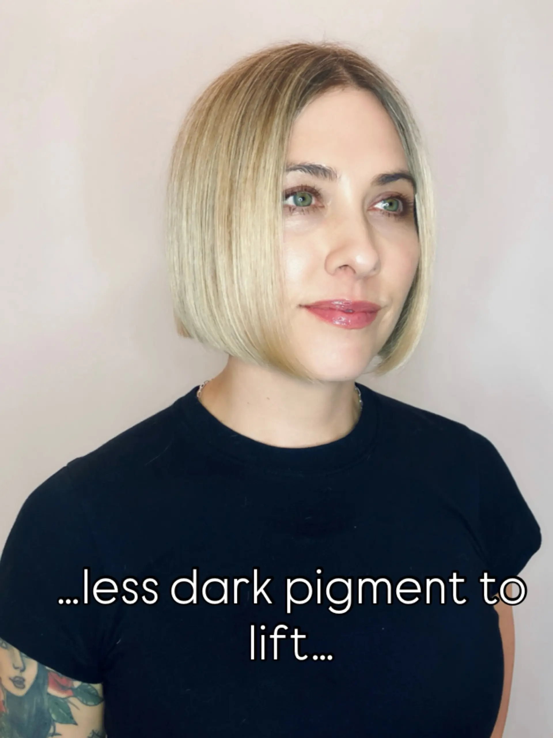 A sleek, chin-length straight bob featuring cool dimensional blonde highlights with a soft root shadow. 1
