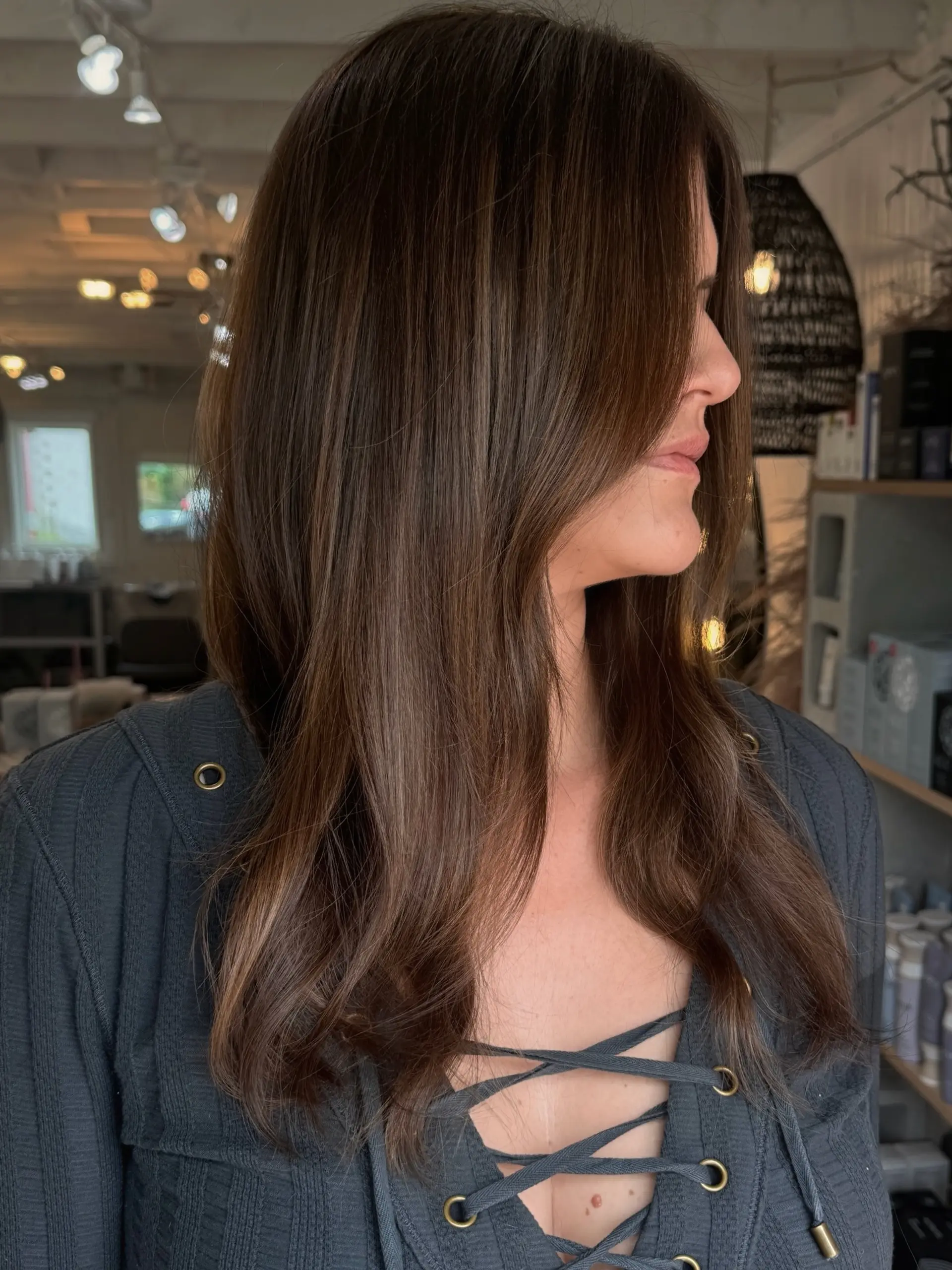 Glossy, long brunette hair with subtle natural highlights and smooth face-framing layers. 1