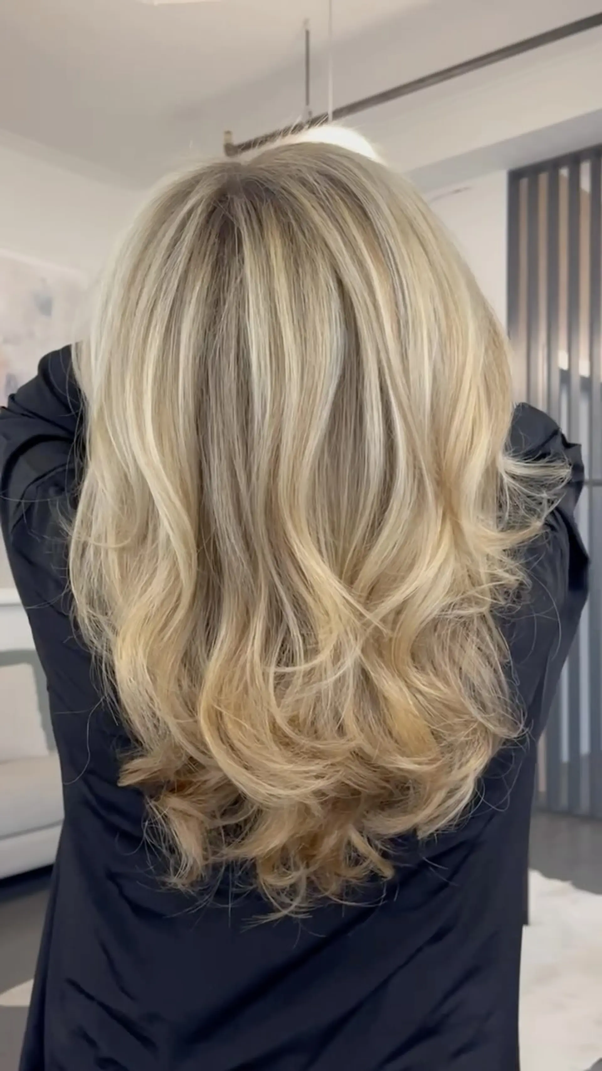 Long layered dimensional blonde balayage finished with a soft, bouncy blowout. 1