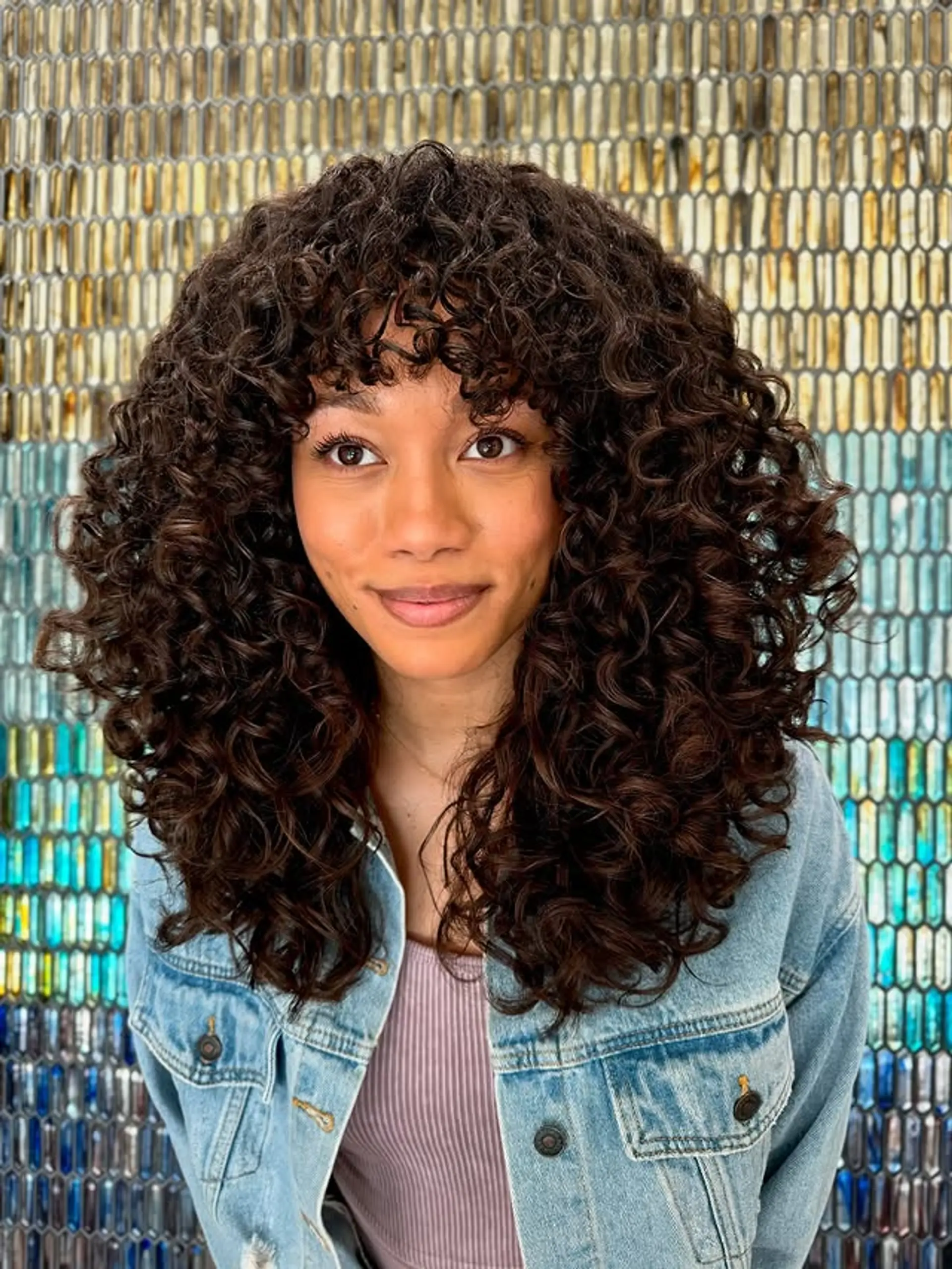 A modern take on the classic shag, featuring lots of layers and curly bangs. 1