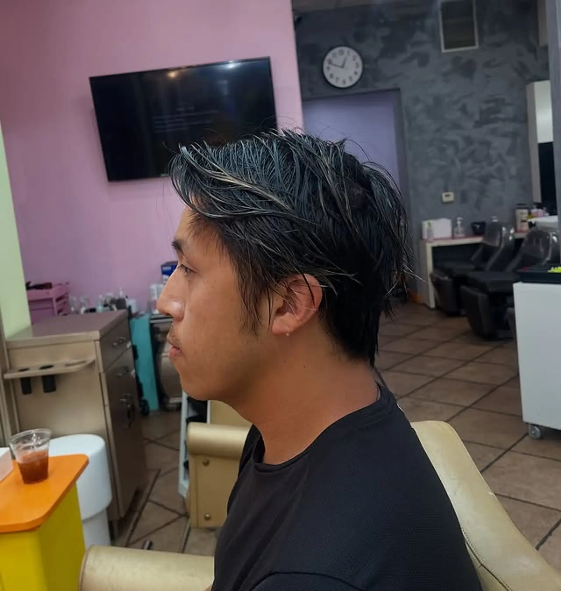 A layered, short textured hairstyle with highlights. 1