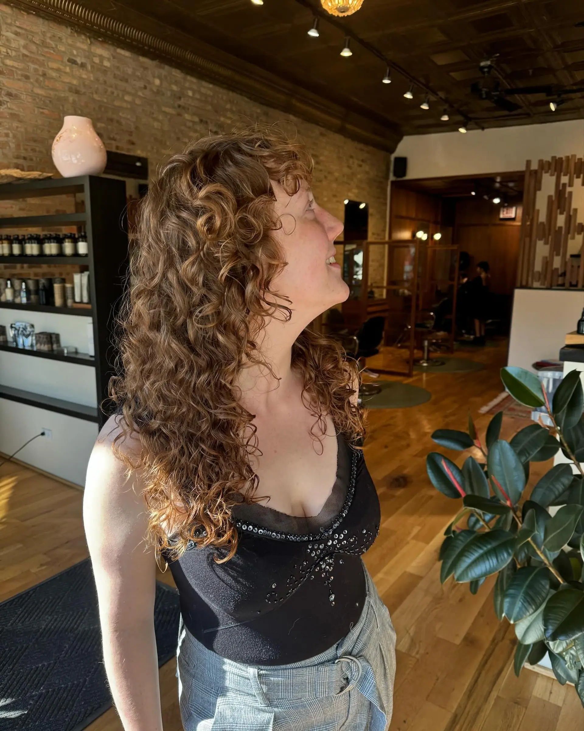 A modern shag haircut with lots of curly layers and face-framing bangs. 2