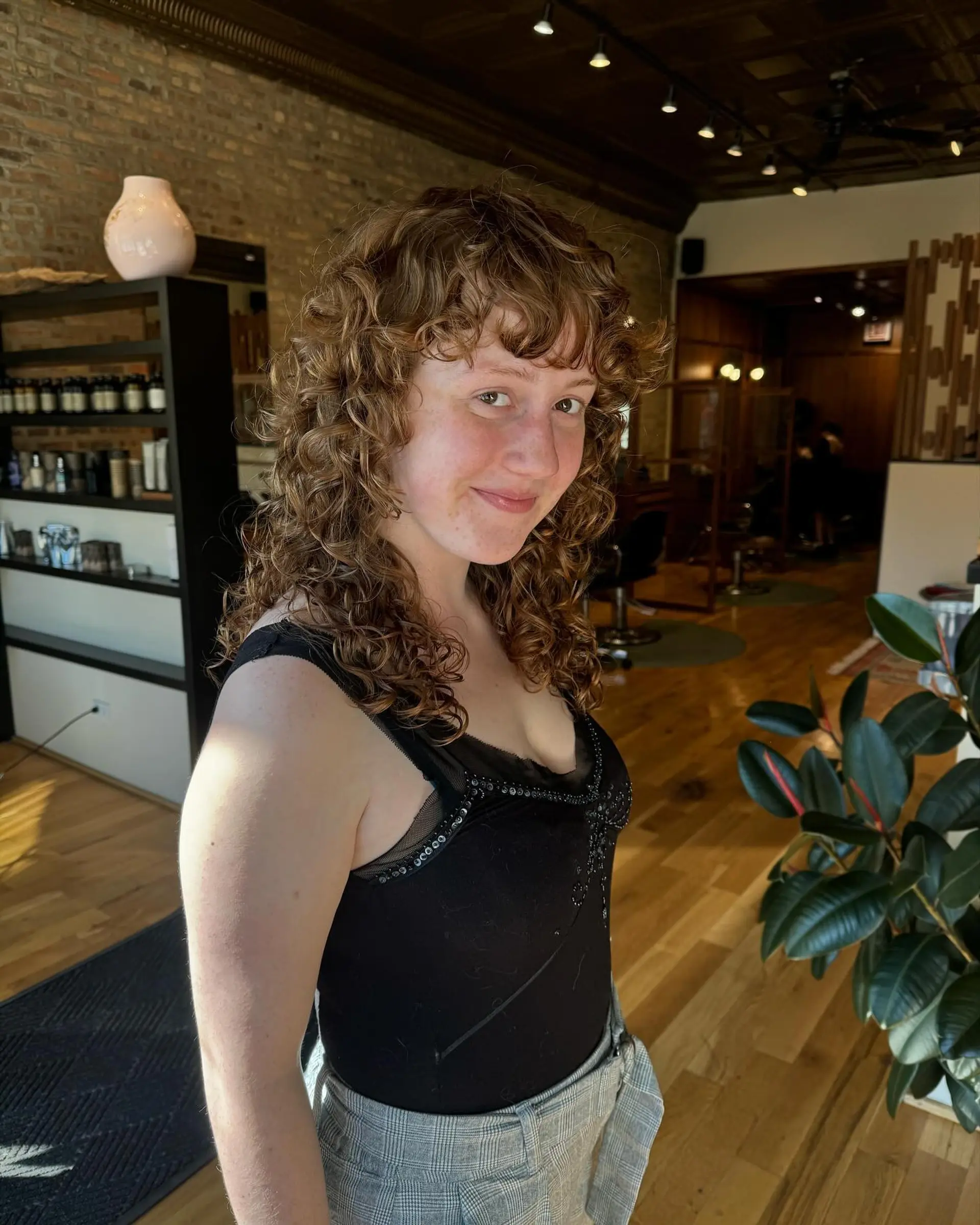 A modern shag haircut with lots of curly layers and face-framing bangs. 3