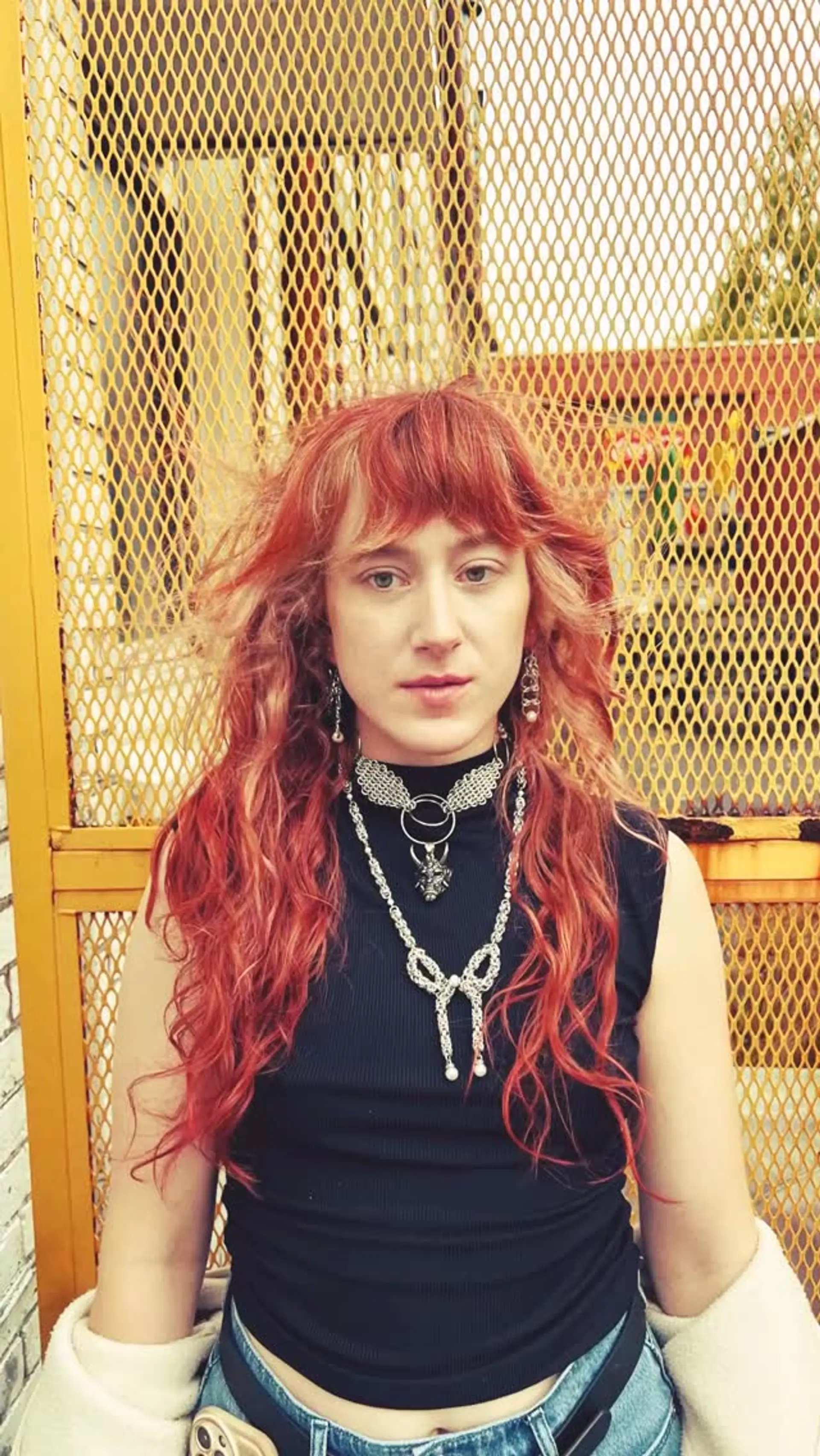 A long, heavily layered copper shag haircut featuring wispy bangs and textured wavy lengths. 1