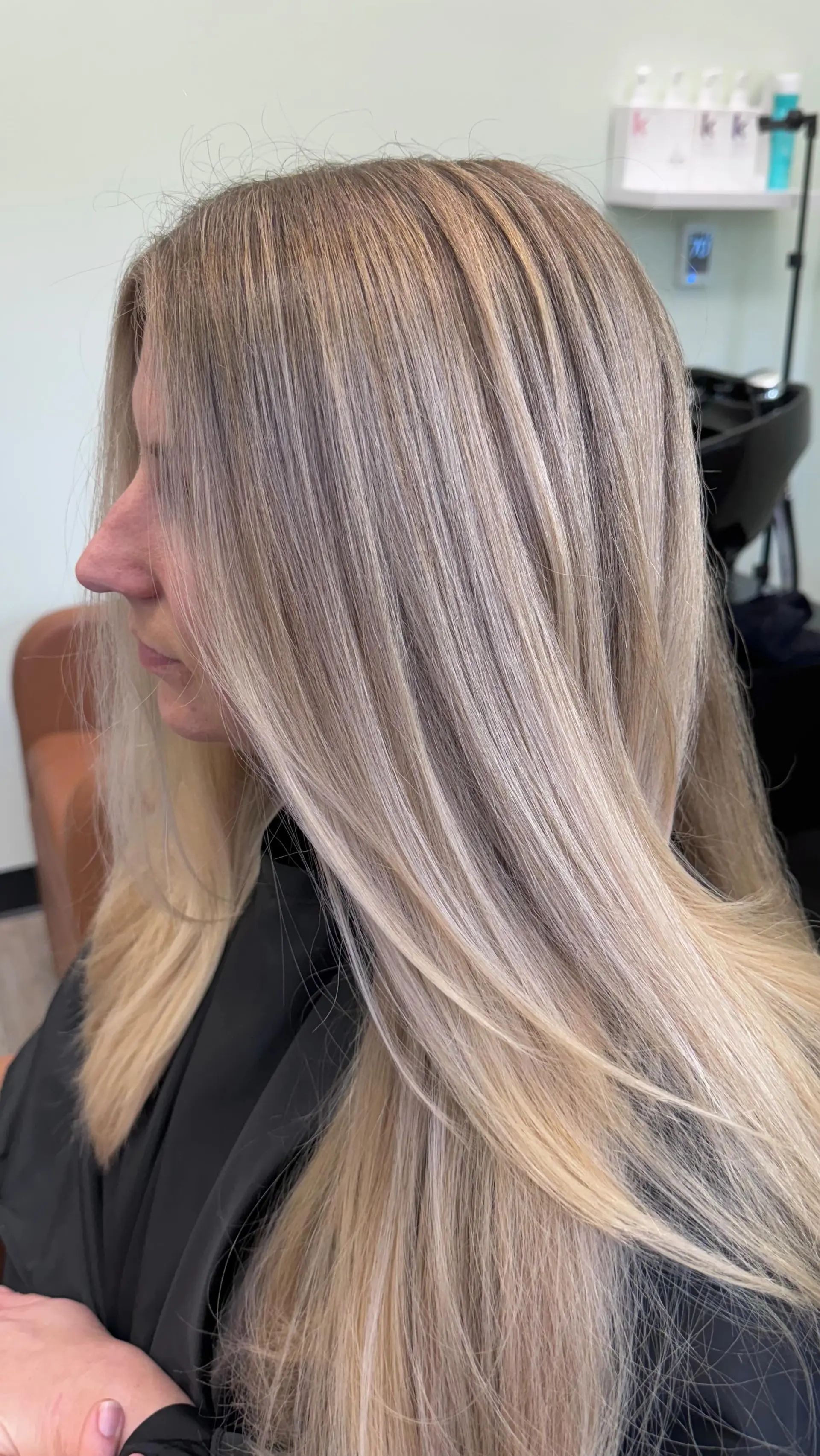 Long straight hair with multi-tonal blonde foil highlights and a sleek finish. 1
