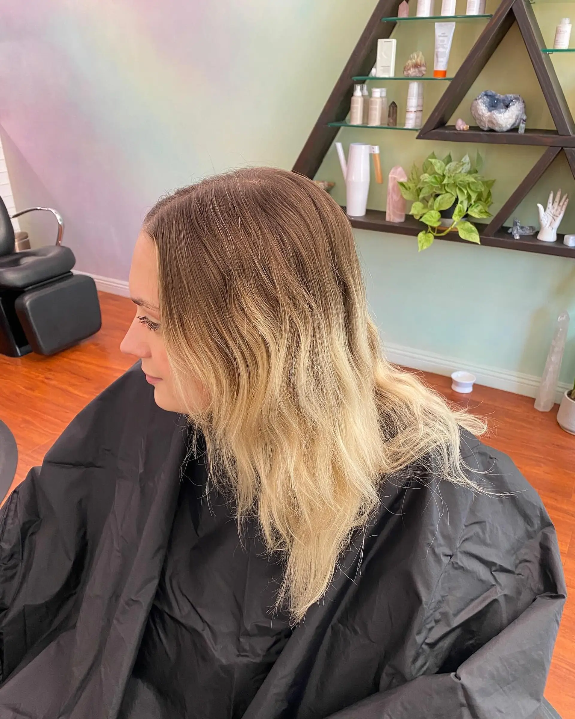 Medium-length lived-in blonde hair featuring fine highlights blended into a natural light brown base with a root tap. 1