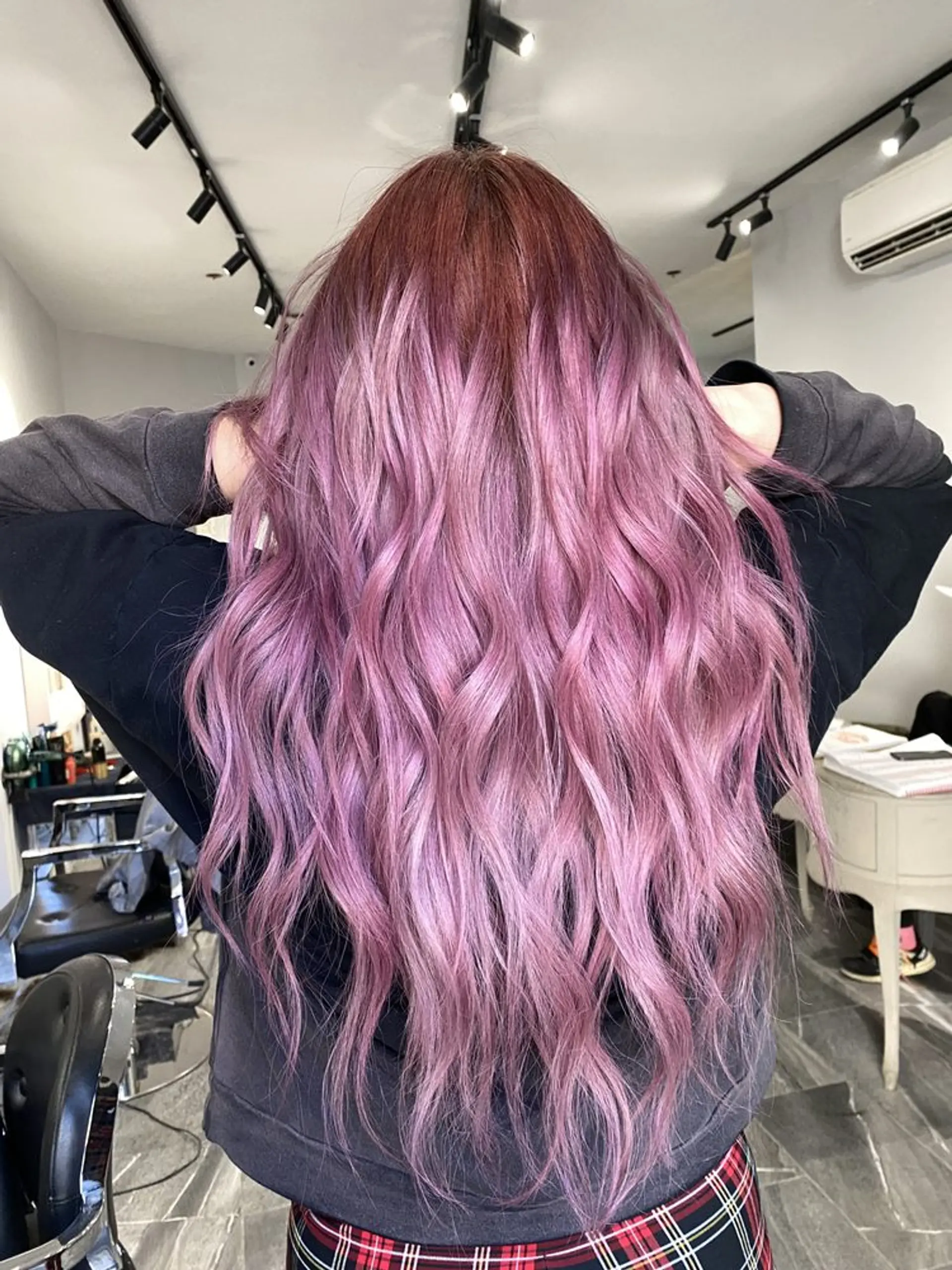 Long, wavy locks dyed in a captivating blend of purple and lavender, flowing down in loose, relaxed waves, creating a dreamy and ethereal appearance. 1