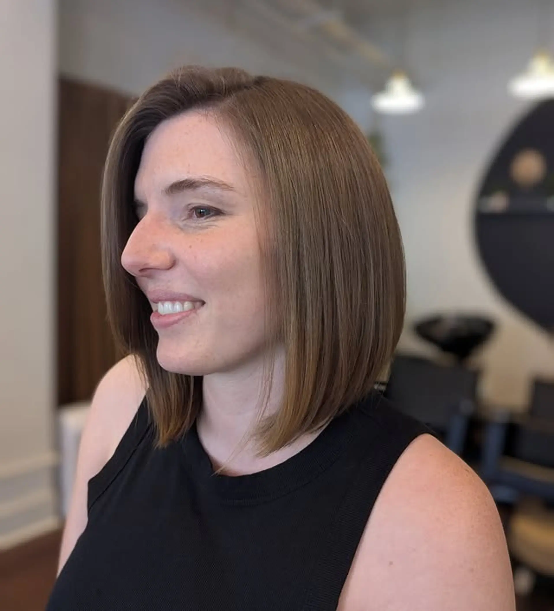 A sleek, chin-length blunt bob with subtle balayage highlights. 1