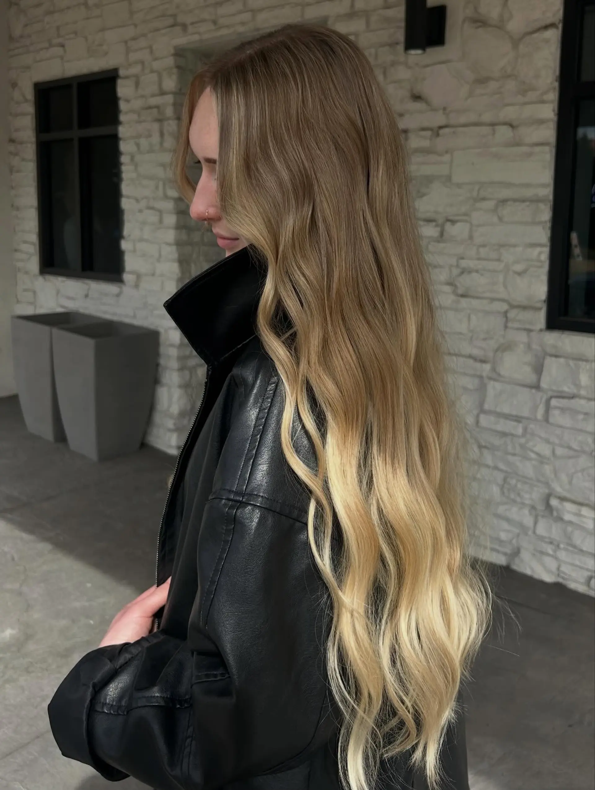Extra-long hair styled in loose waves, transitioning from a natural dark blonde base into bright blonde ends. 1