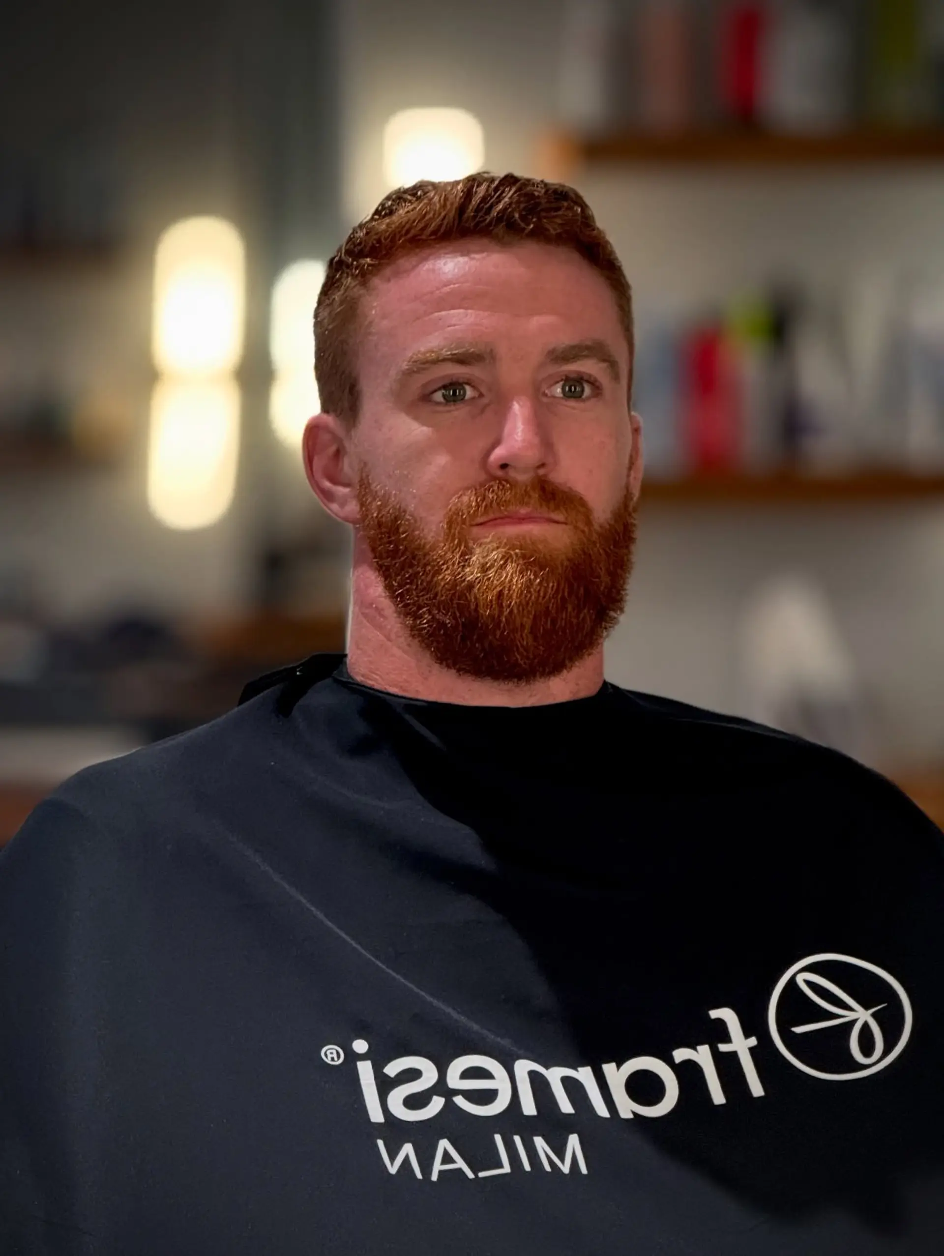 A clean short men's crop with neatly tapered sides, paired with a full, expertly shaped and groomed red beard. 1