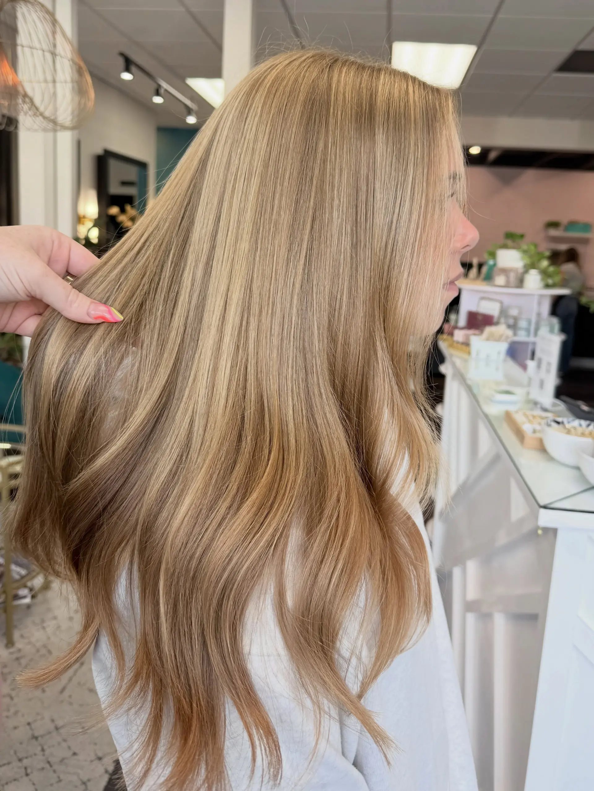 Silky, long golden blonde hair with a seamless, multidimensional balayage blend and soft texture at the ends. 1