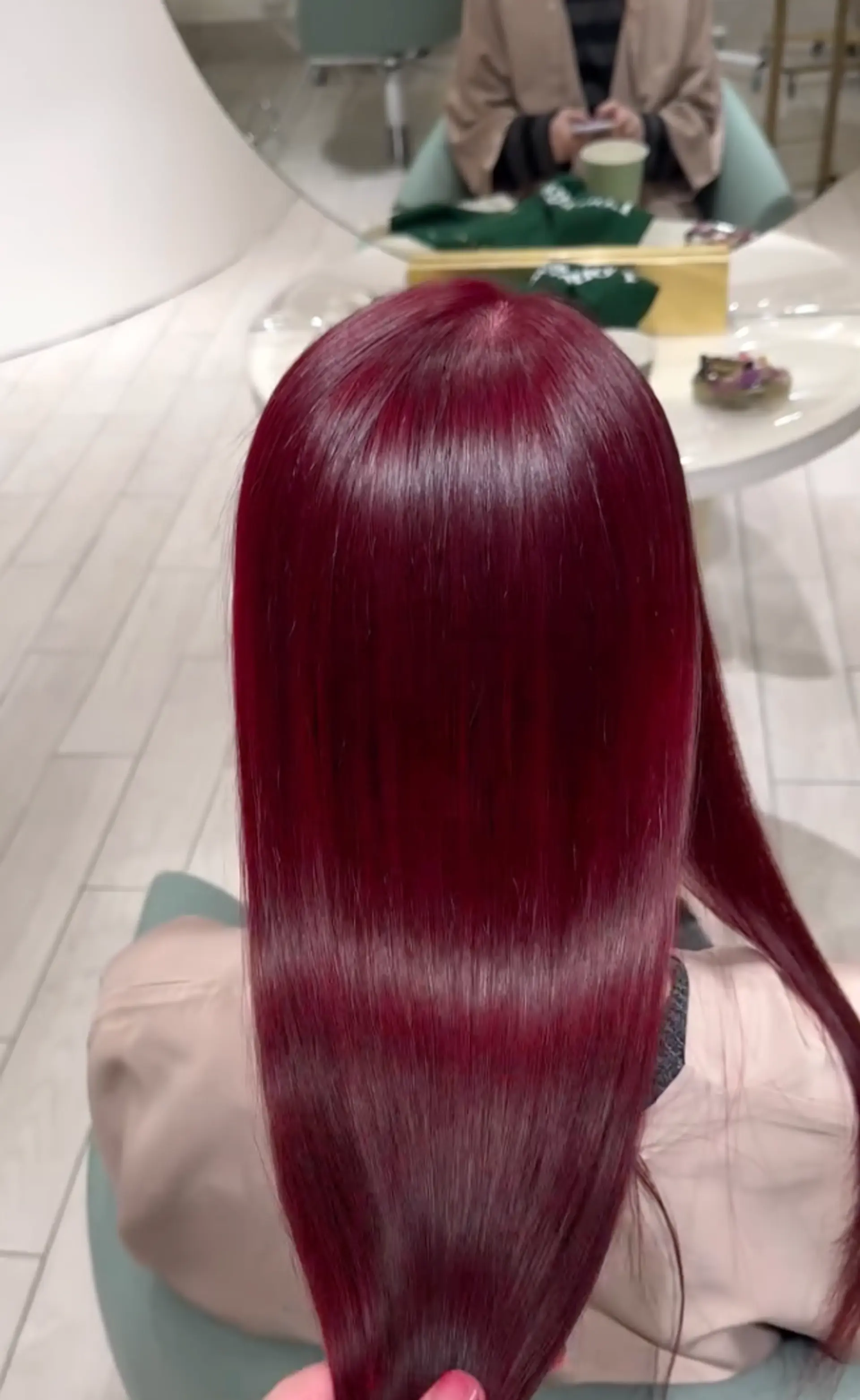 Long, straight hair with a stunning, glossy burgundy color. 2
