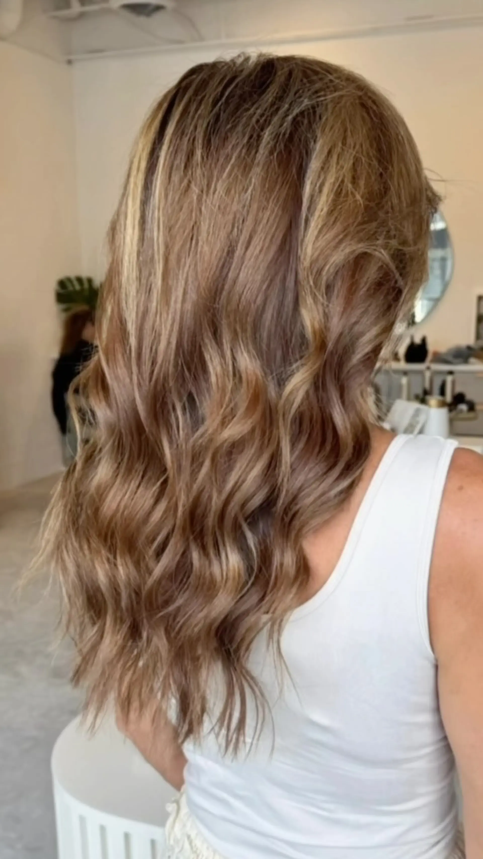 Long dimensional caramel and honey-toned hair styled in soft, loose waves. 1