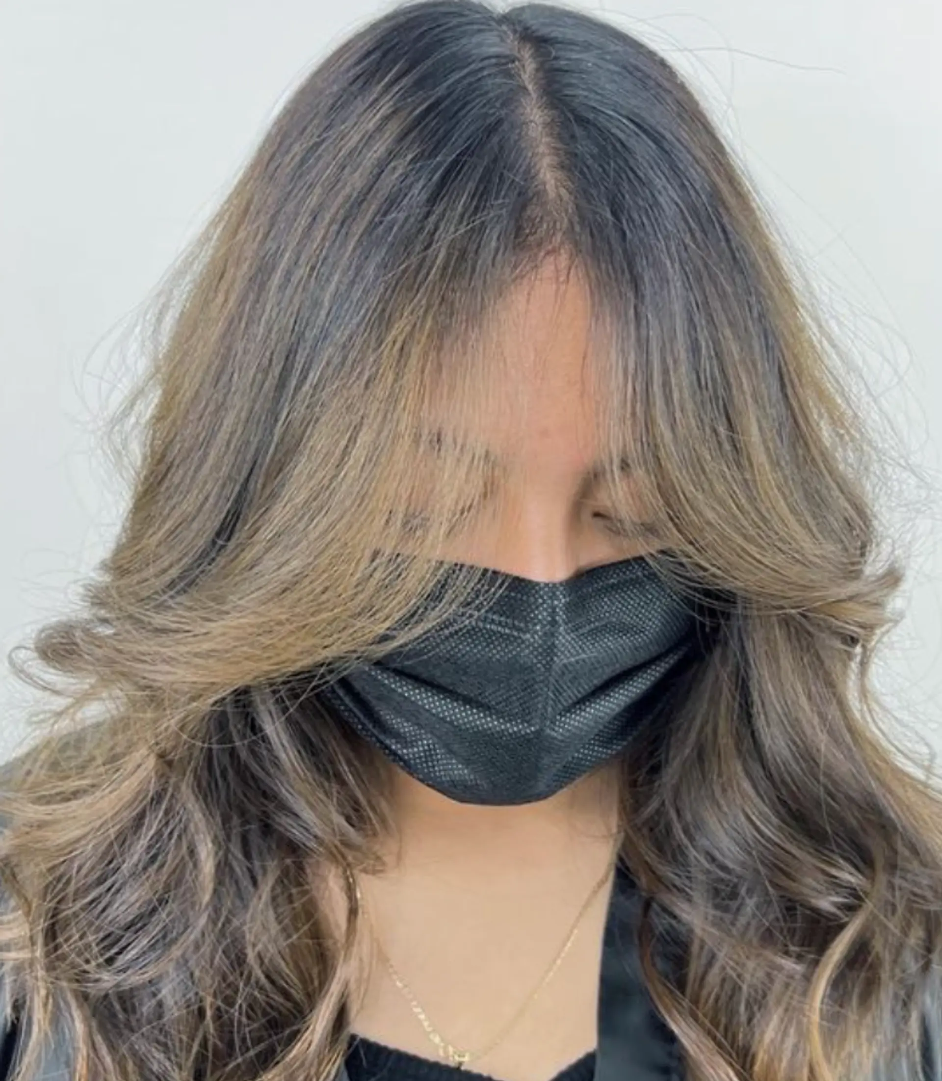 Golden Waves is a beautiful hairstyle with long, wavy layers and soft, face-framing waves highlighted with blonde and dark brown hues. 1