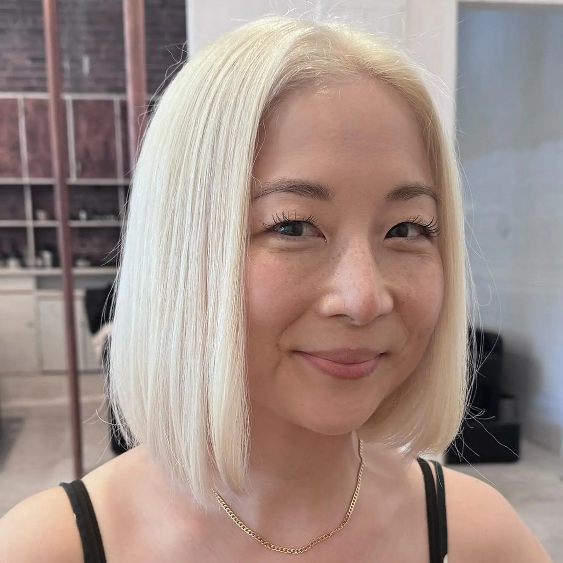 A sleek, medium-length bob with a blunt cut, straight and dyed a striking platinum blonde. 1