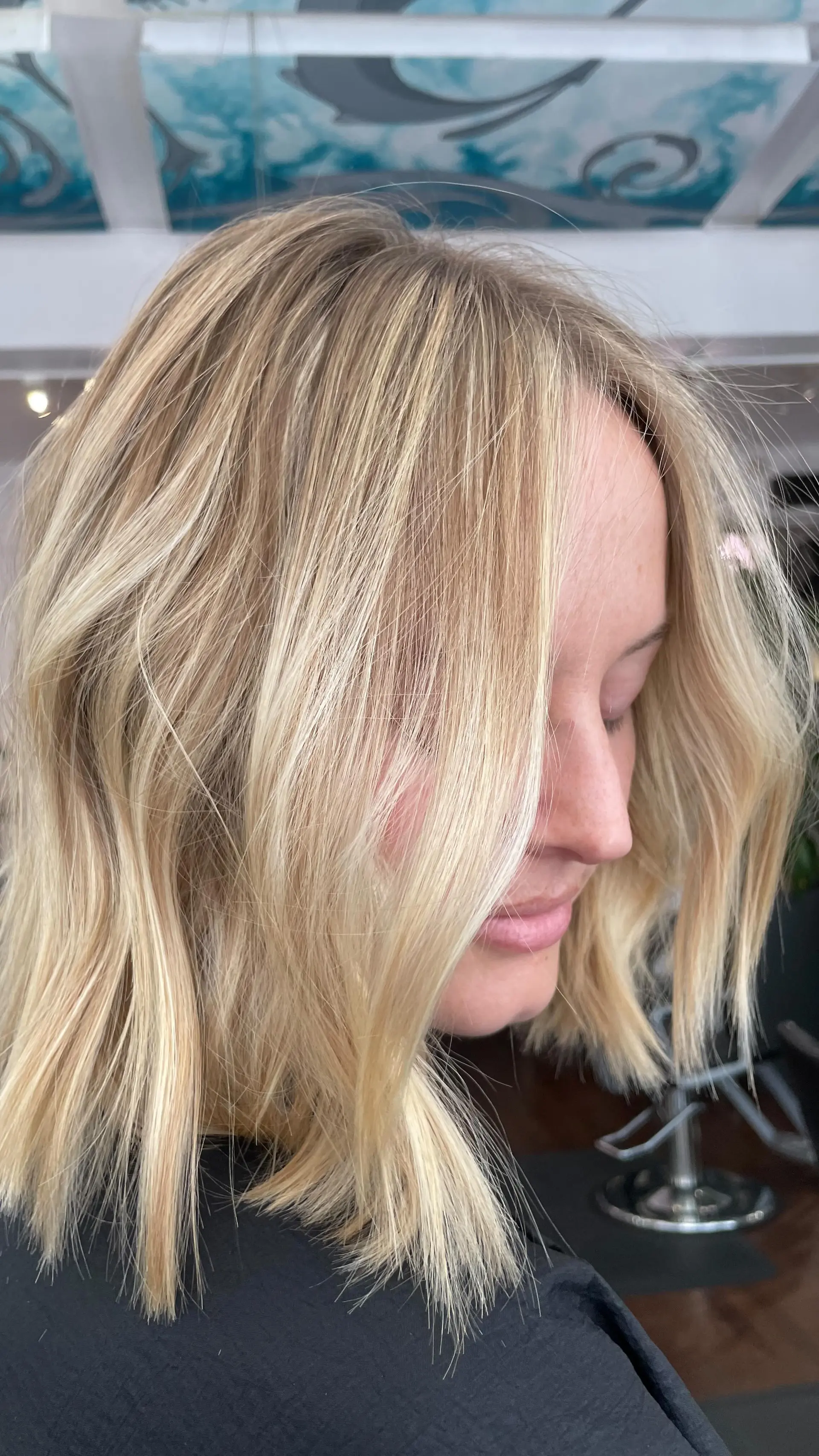 A textured blonde bob cut with bright multidimensional highlights and soft, effortless styling. 1