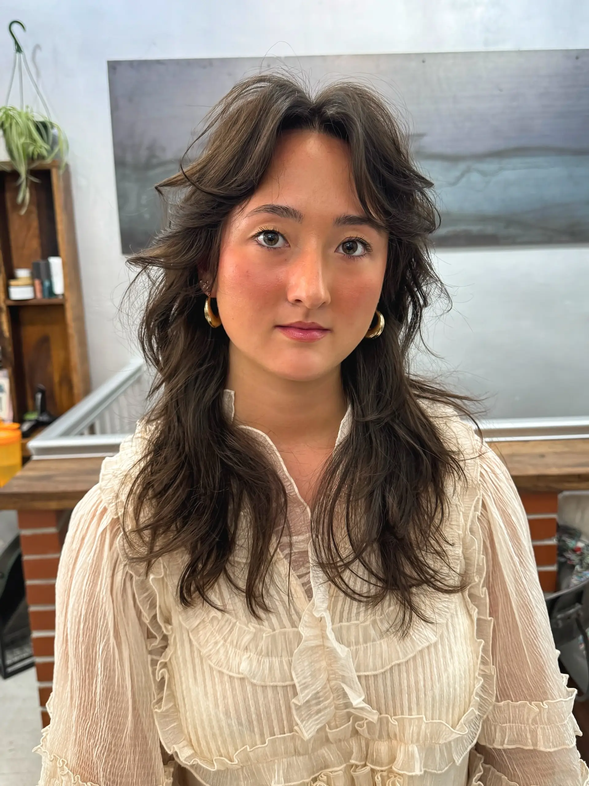 A trendy shag haircut with face-framing layers and soft curtain bangs. 1