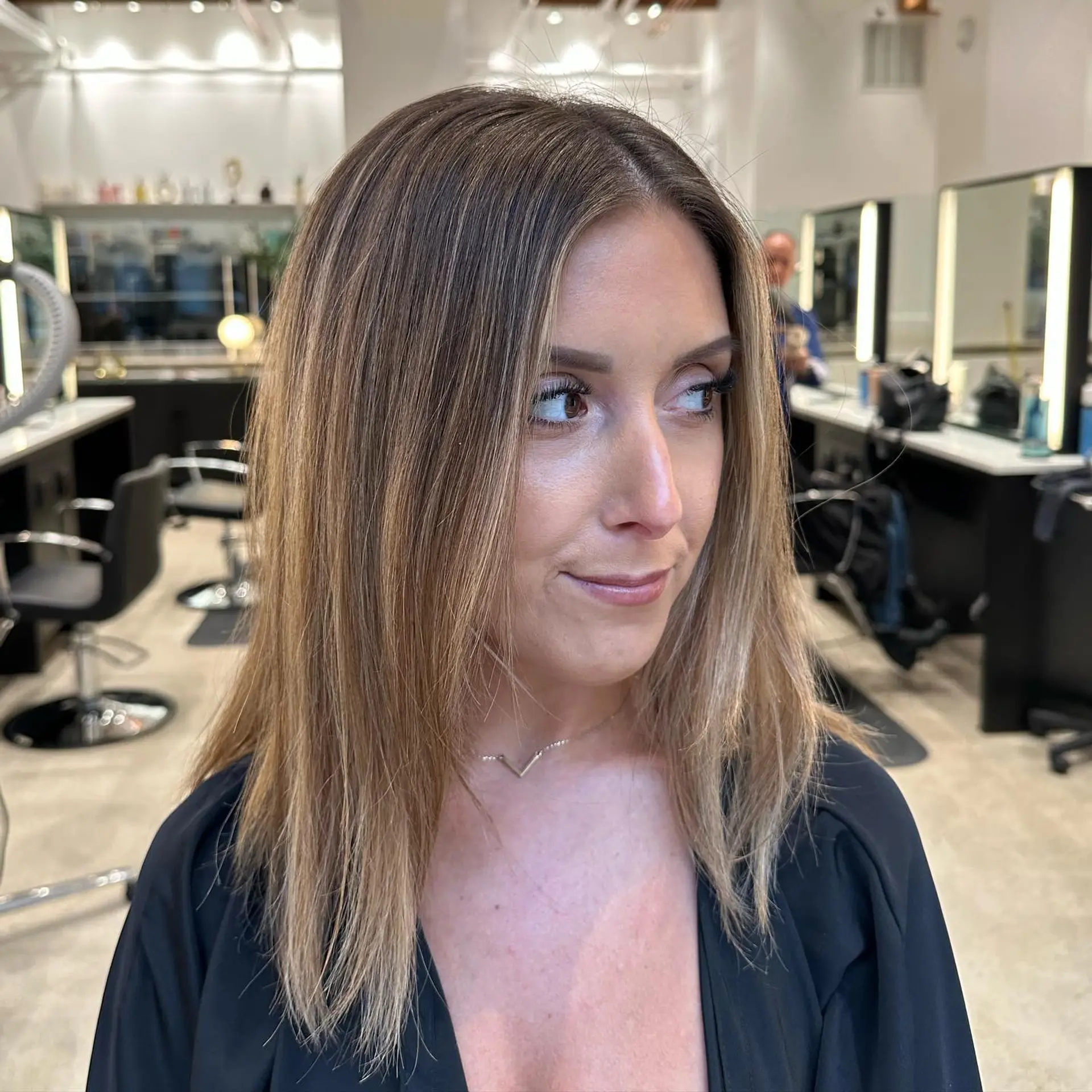 A medium-length hairstyle with beachy waves and balayage. 2