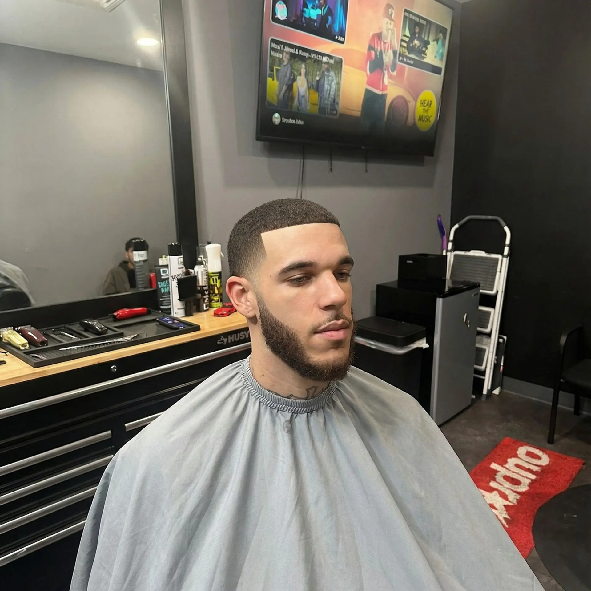 A clean buzz cut featuring a razor-sharp hairline and a seamless temple taper blending into a groomed beard. 1