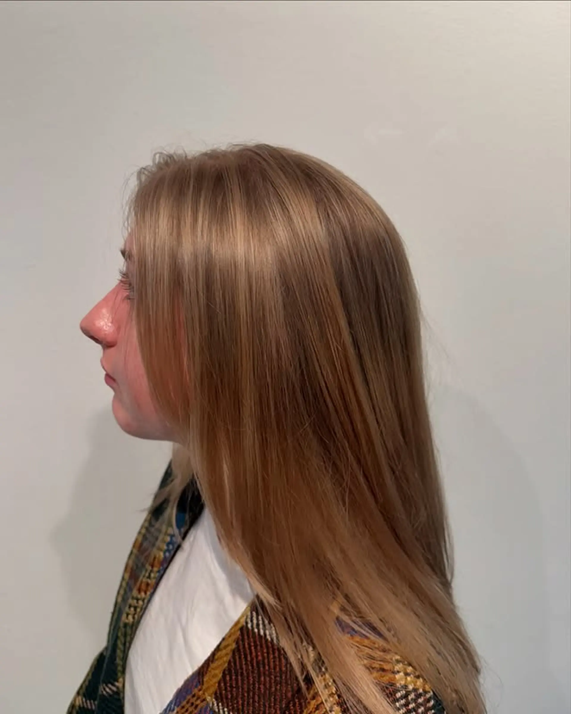 Long layered hairstyle with a blended brown and blonde balayage for a natural, dimensional look. 1