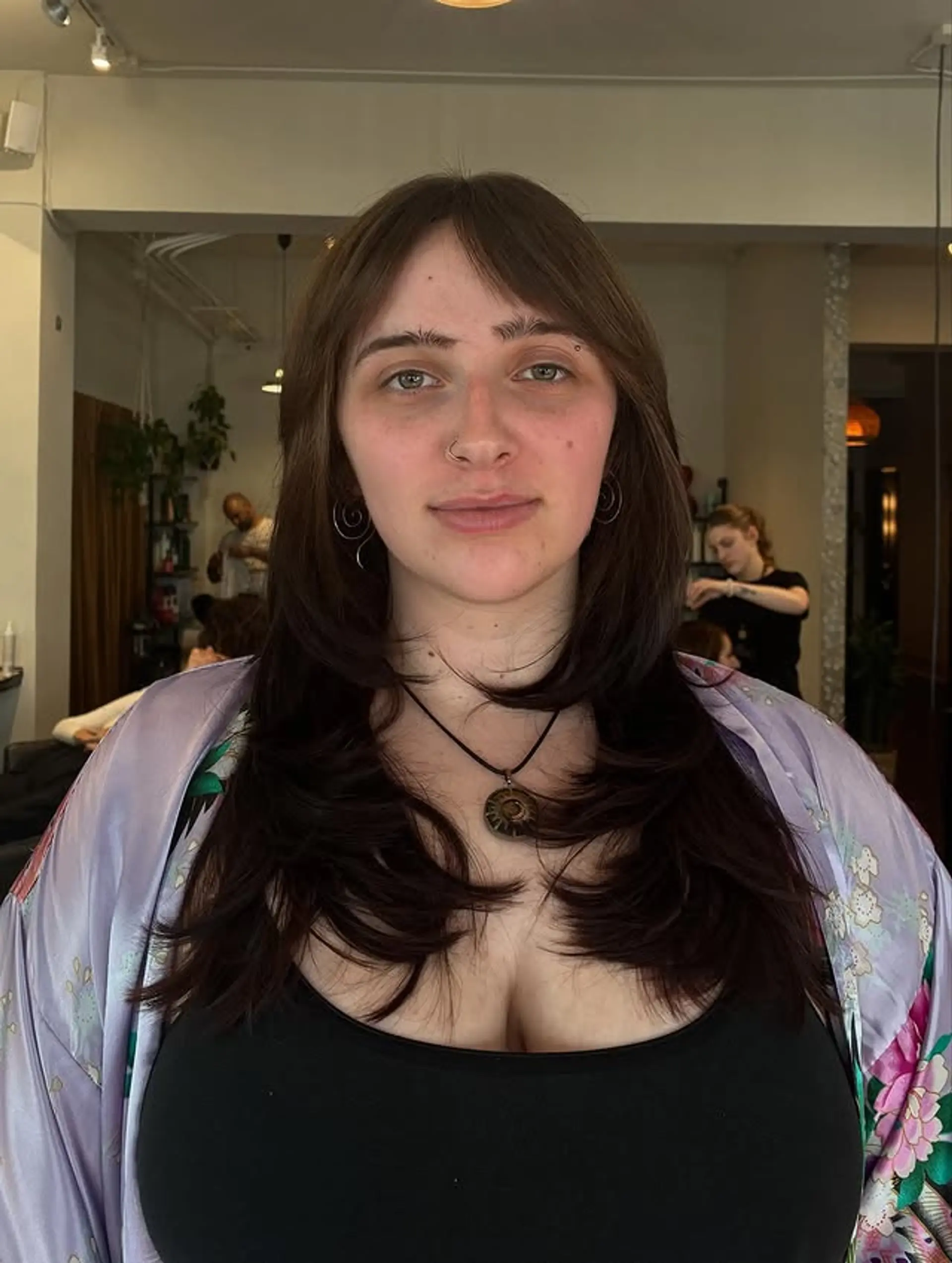 A layered shag haircut with face-framing layers and fringe bangs. 1