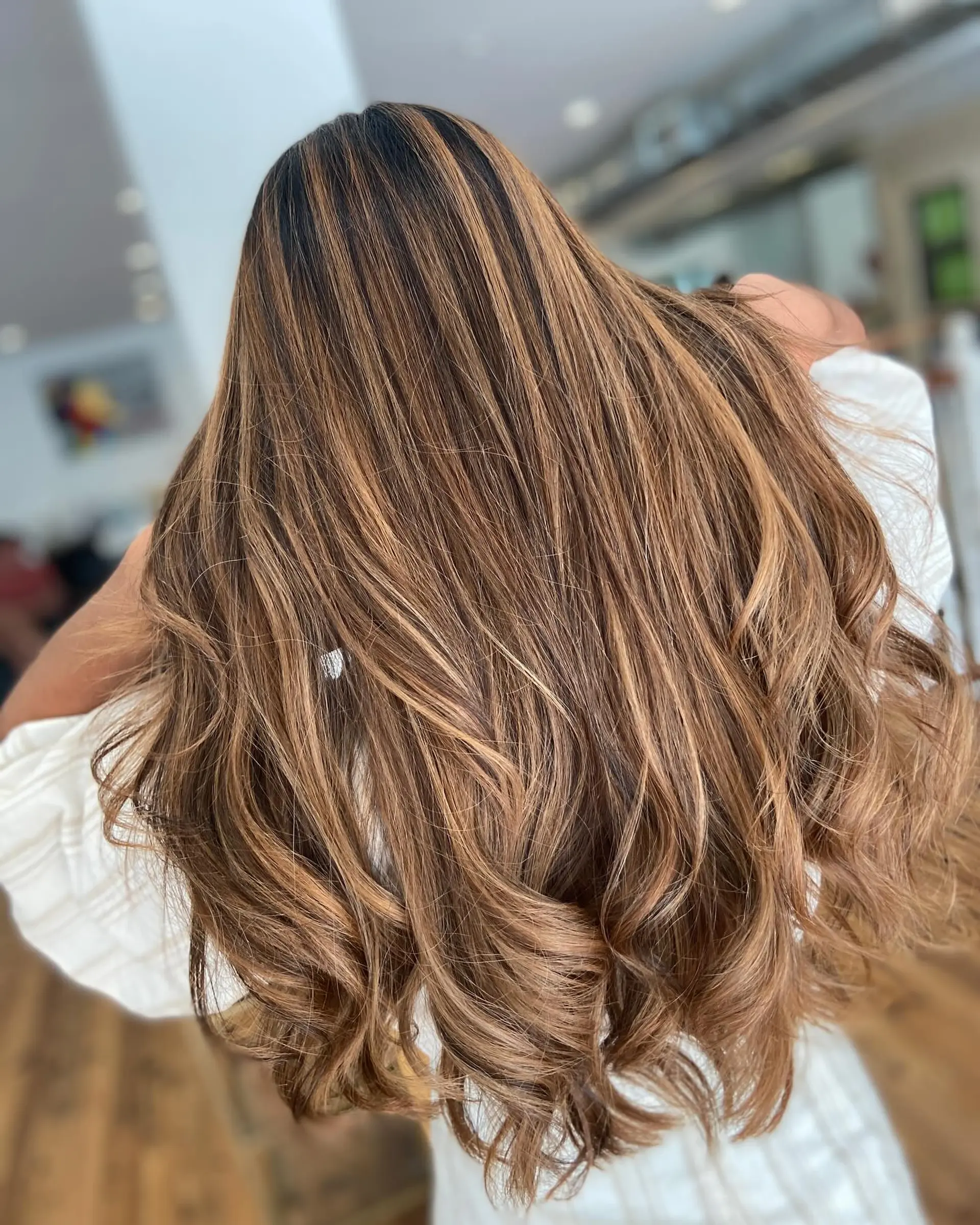 Long, wavy hair with a layered bronde balayage. 2