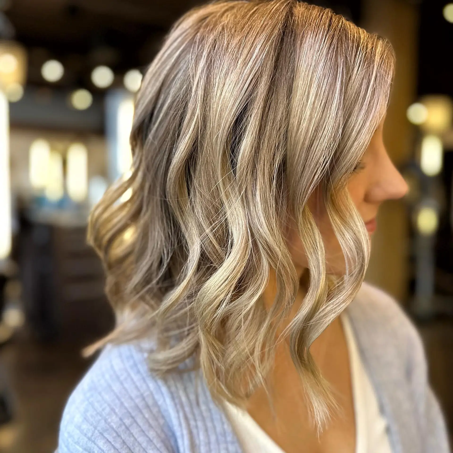 A medium-length wavy hairstyle with a bronde balayage. 1