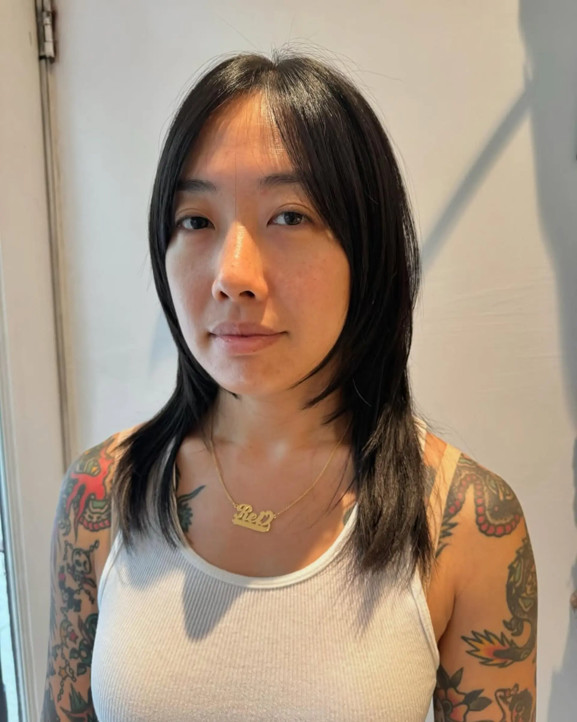 A medium-length shag with layered texture and curtain bangs. 1