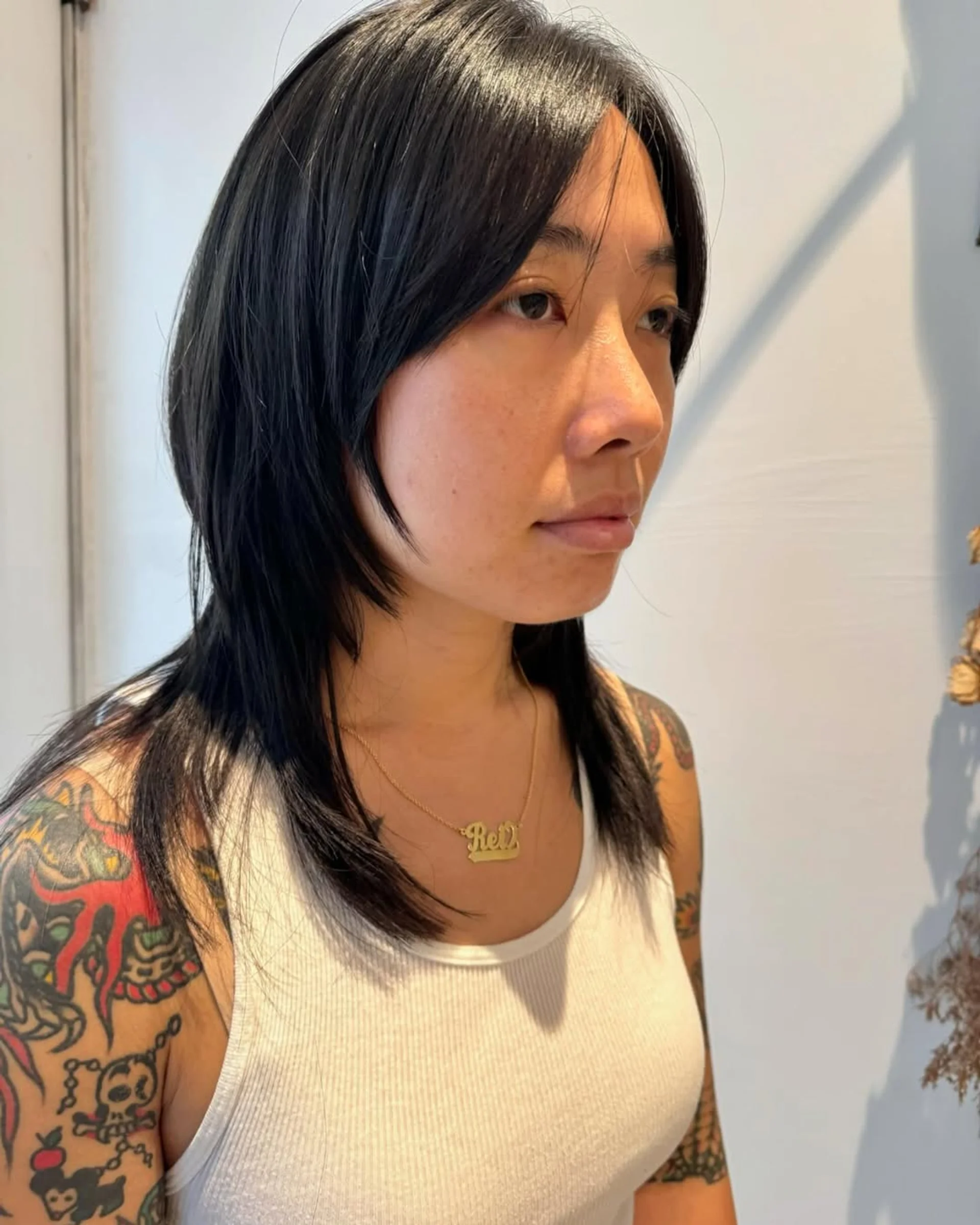 A woman with a trendy retro shag haircut and curtain bangs, a key 2025 hair trend in NYC. - Preview 2