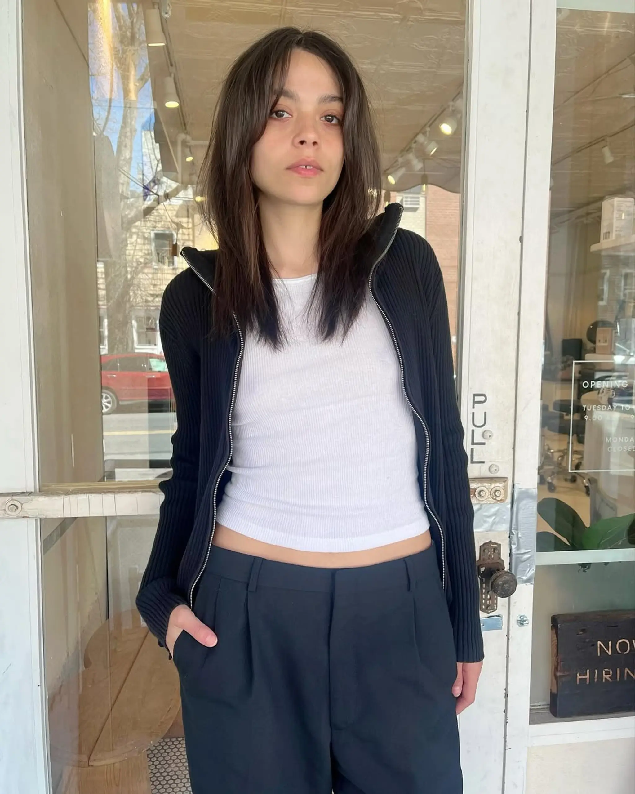Modern layered shag with curtain bangs, featuring face-framing layers and tapered ends, adding depth and movement to the look.