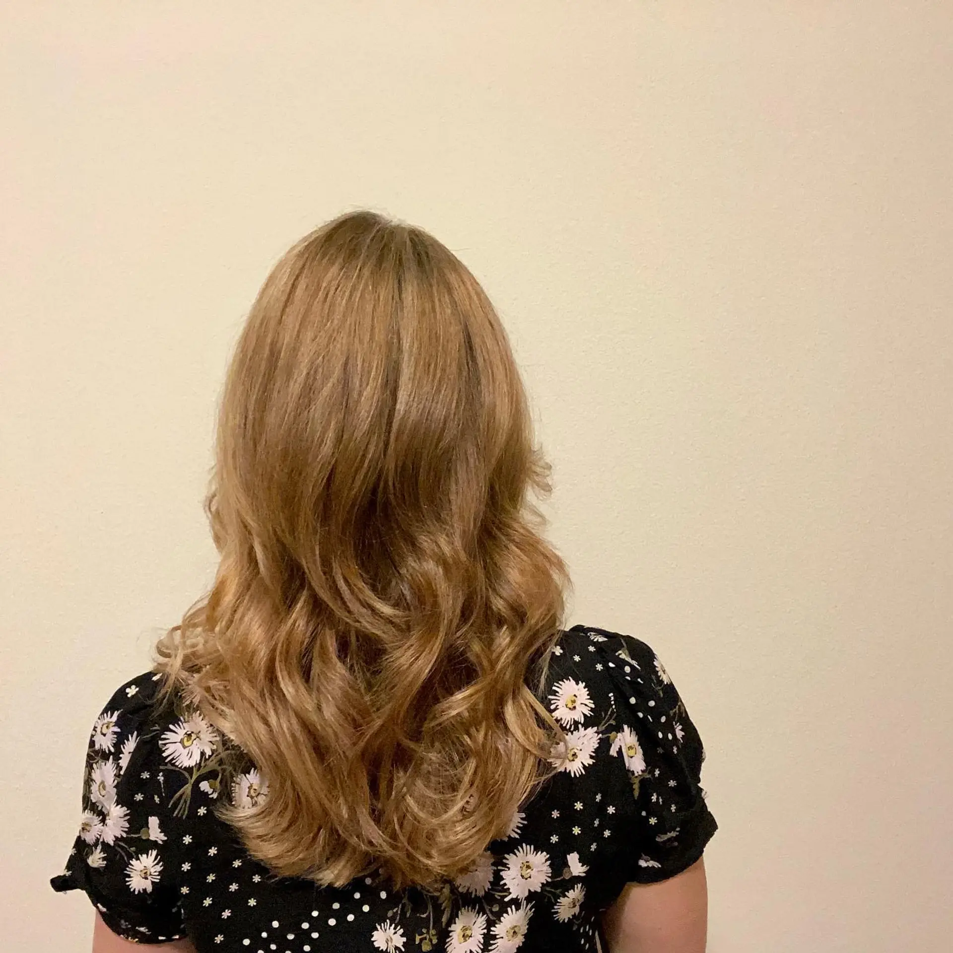 Long honey blonde hair styled in soft, bouncy waves with subtle textured layers. 1