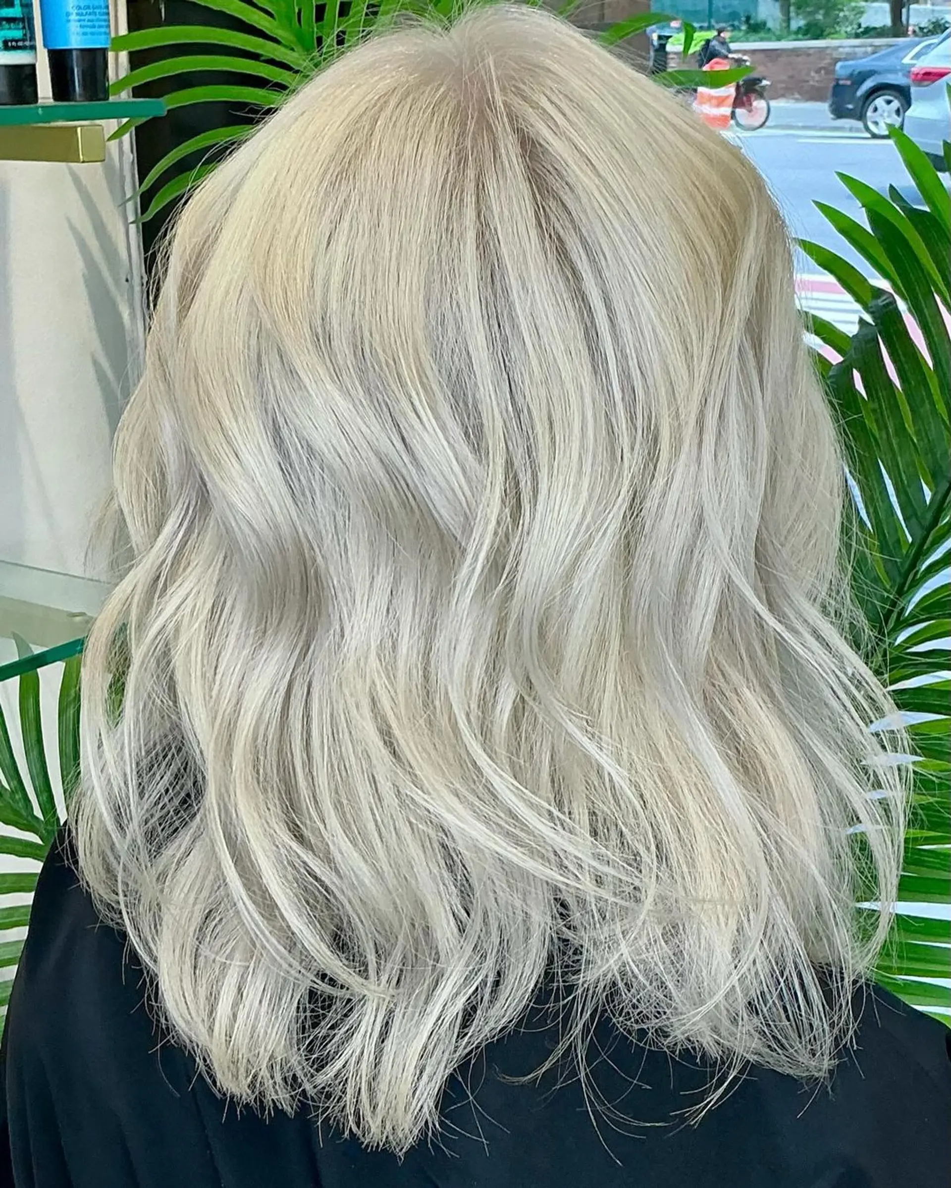 Medium-length platinum blonde hair with soft, textured waves and luminescent shine, featuring natural flow and soft layers. 1