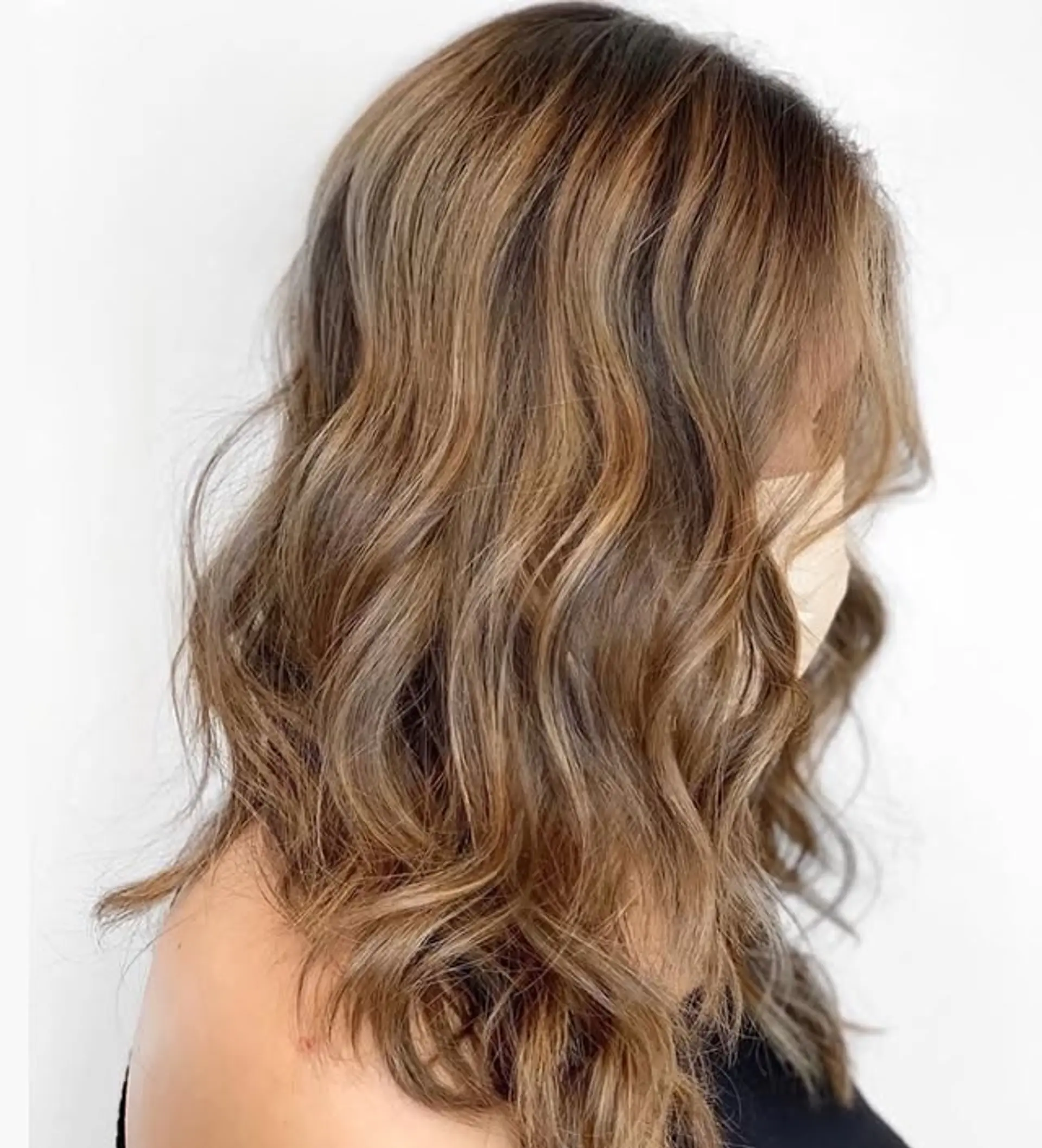 A wavy lob with caramel balayage highlights and styled with loose, beachy waves. 1