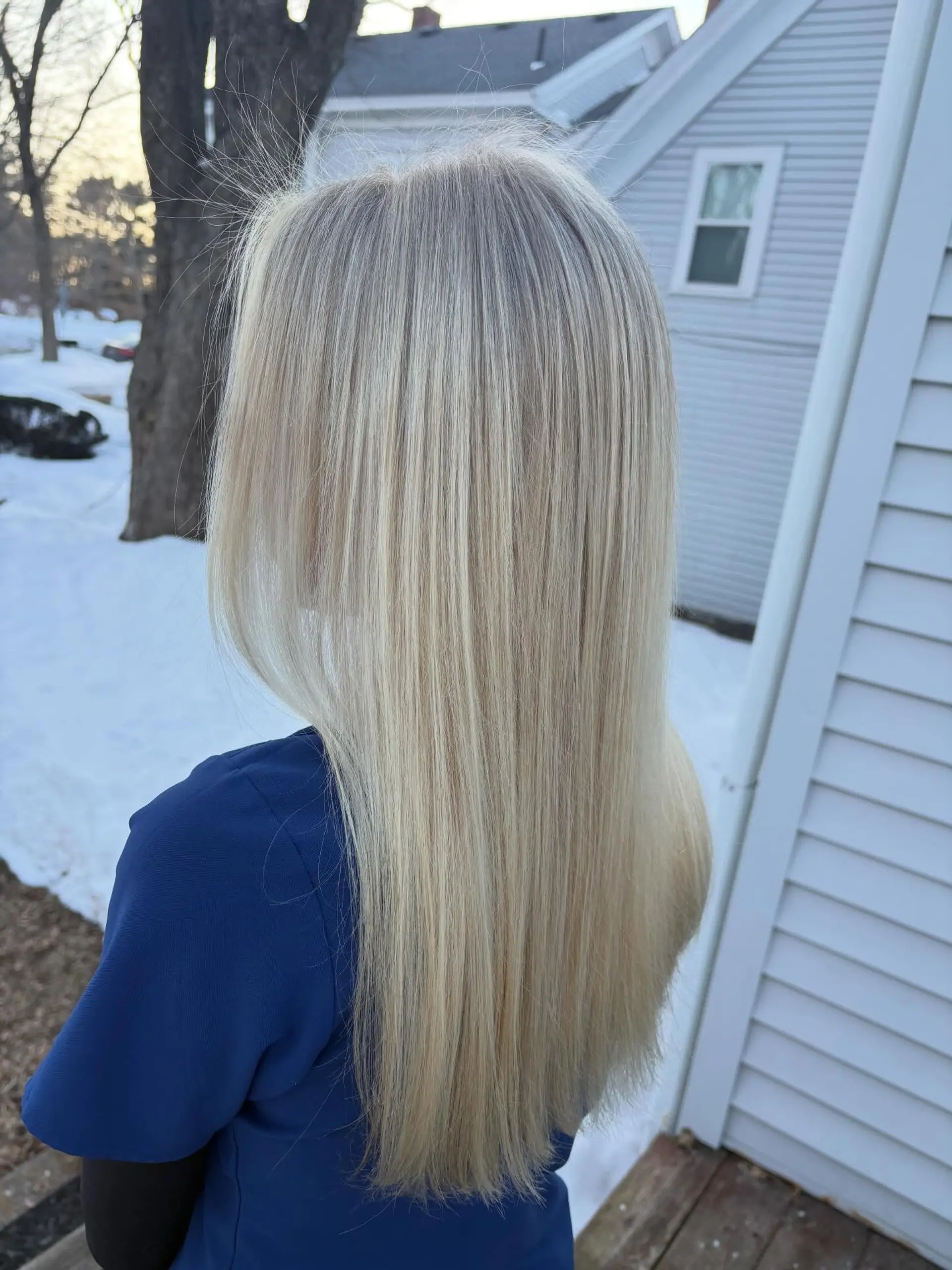 Long, pin-straight blonde hair styled smooth with fine, bright cool-toned highlights from root to tip. 1