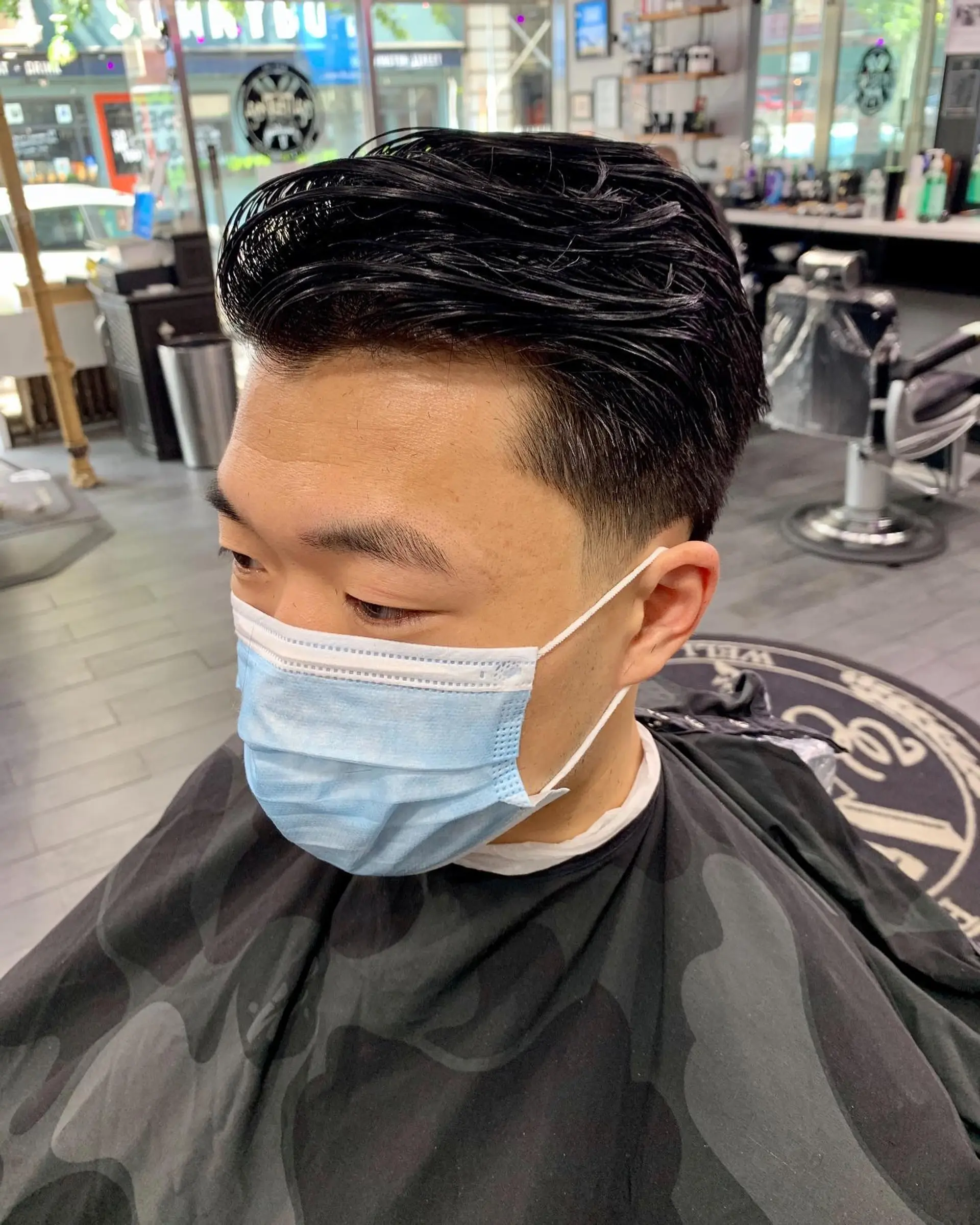 A textured scissor-cut style swept back with a natural sheen and cleanly tapered sides. 1