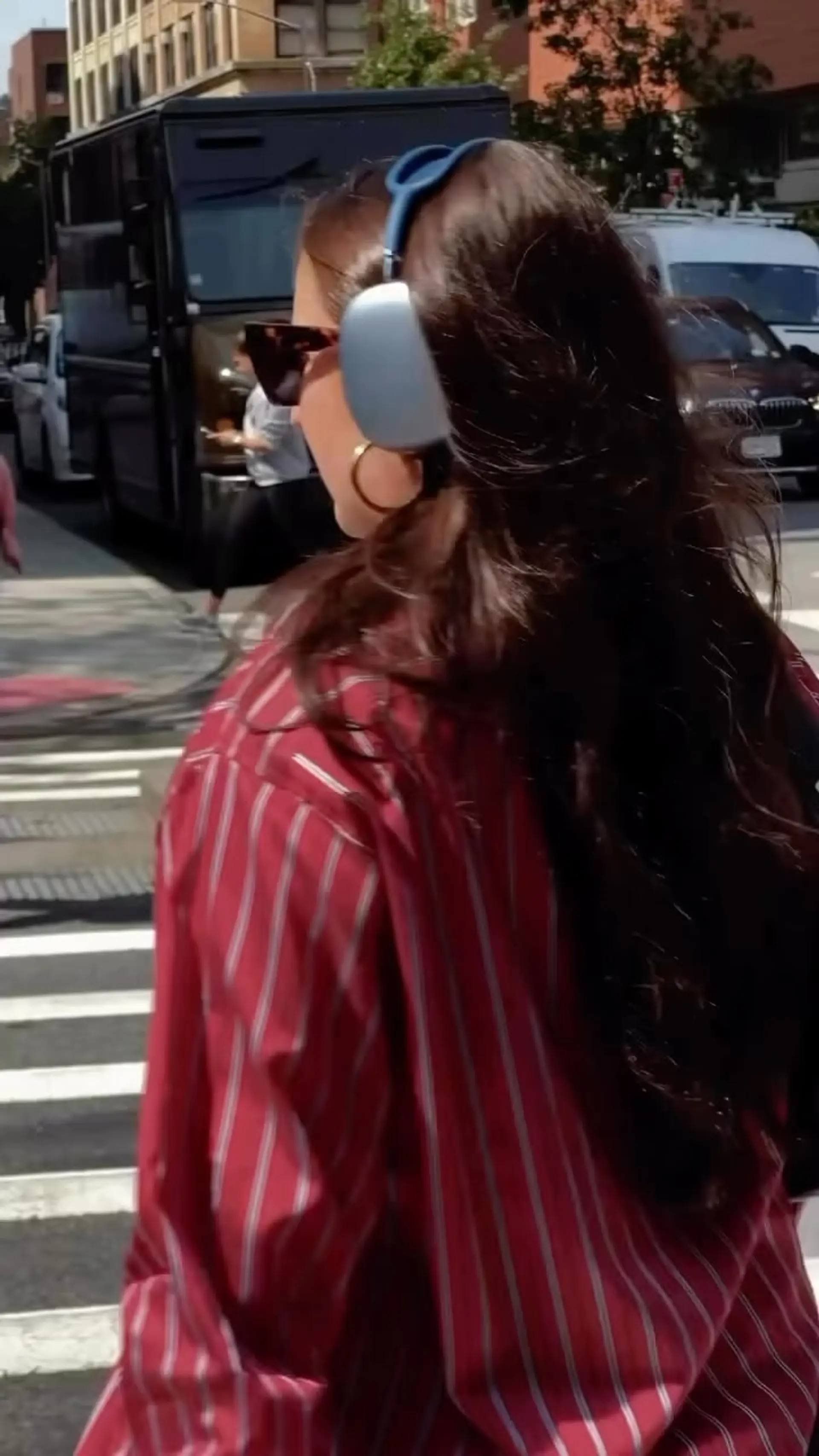 Long, glossy brunette hair styled with soft, voluminous natural waves falling over the back. 1
