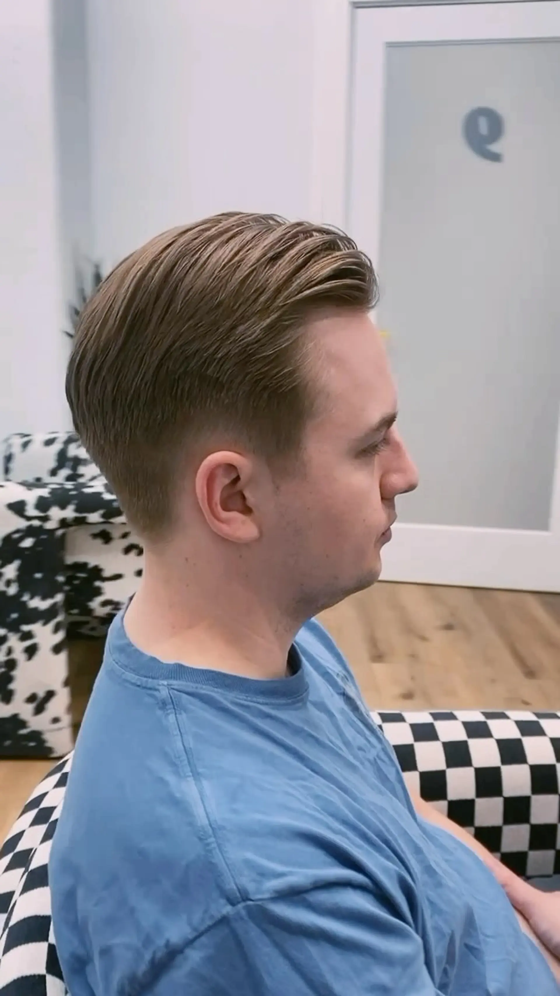 A classic short men's haircut with length styled swept back on top and cleanly tapered sides. 1