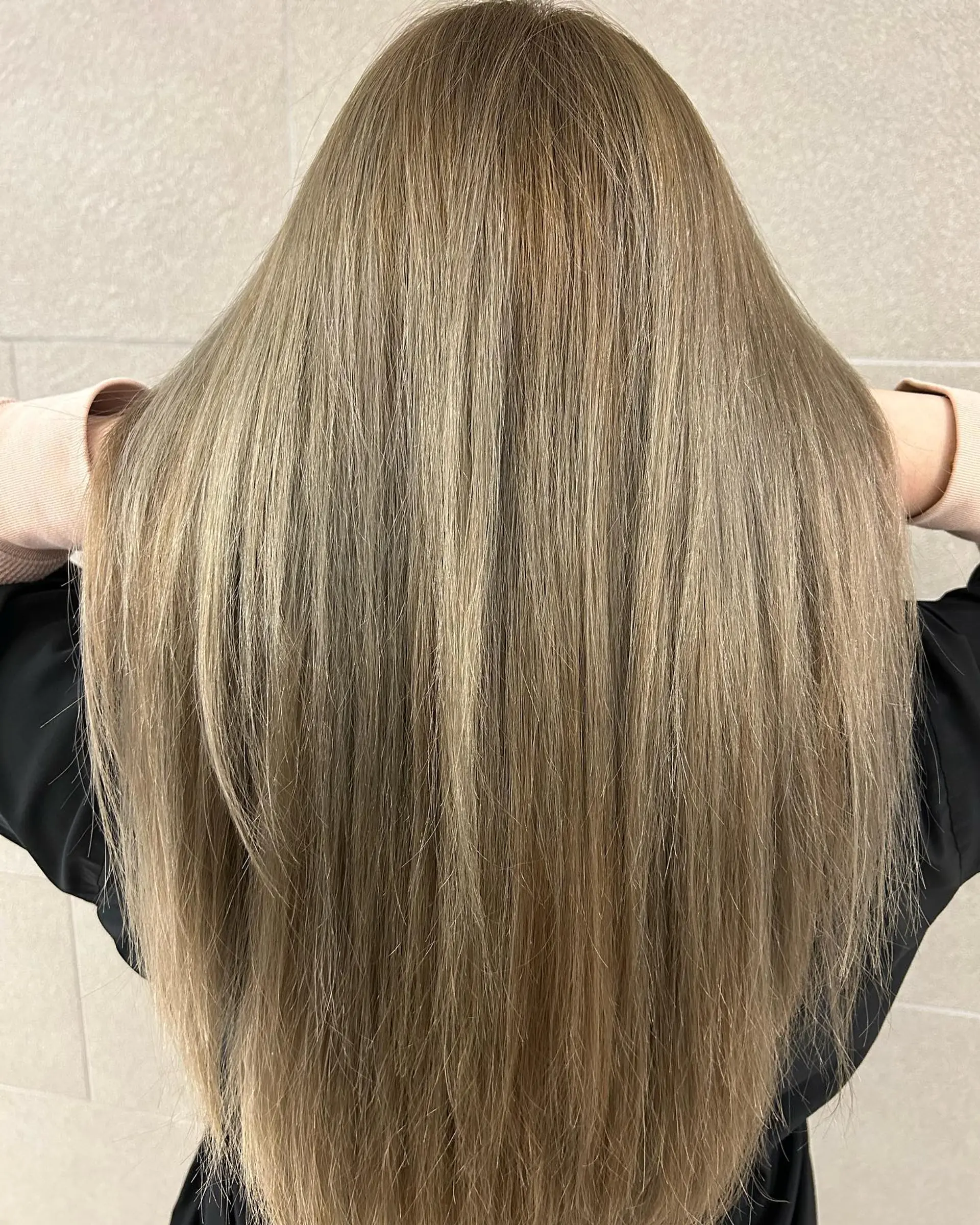 Straight, smooth long hair finished in an even, cool-toned light ash brown tone. 1