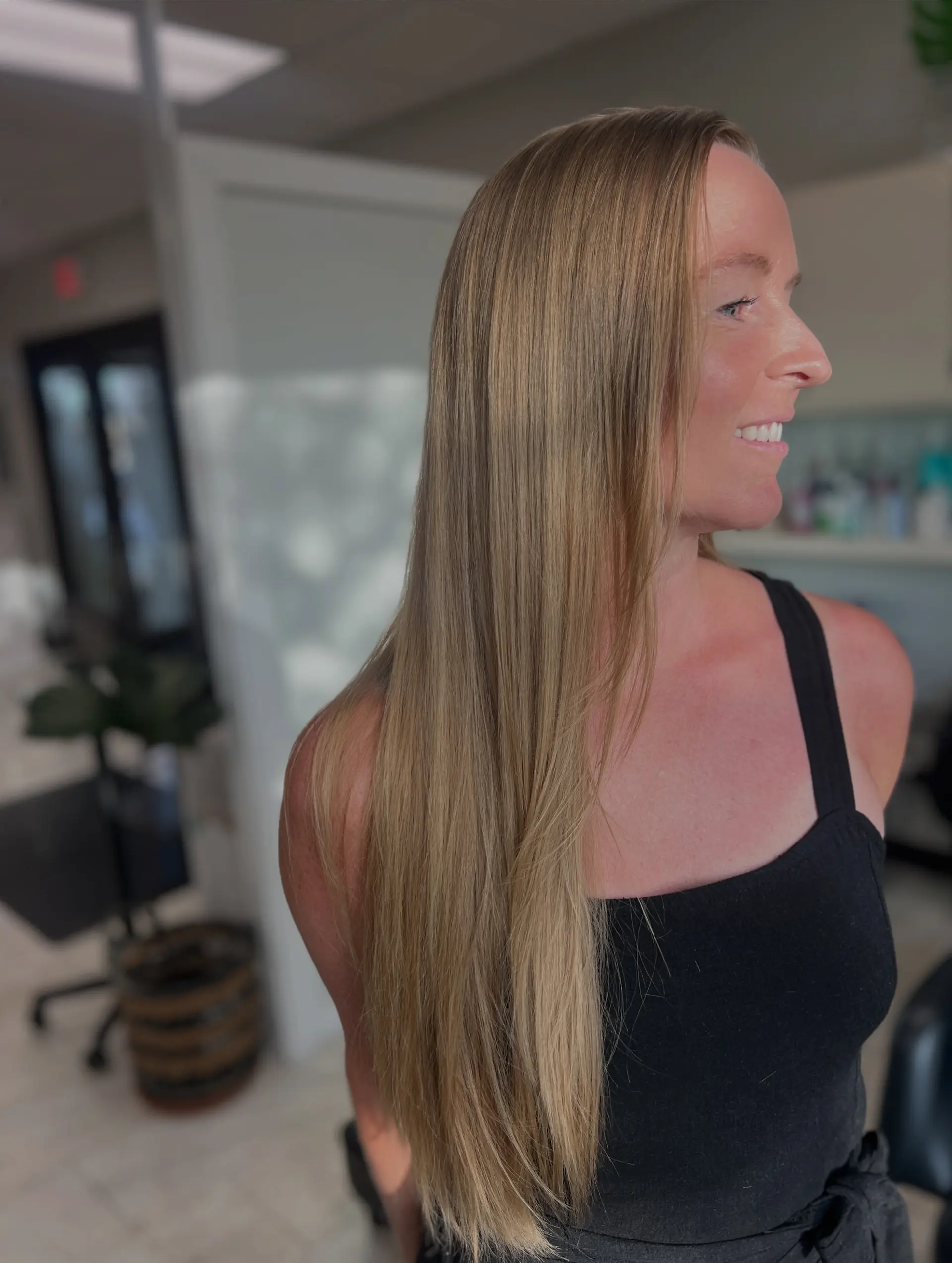 Long, straight natural dirty blonde hair with soft, seamless layers. 1