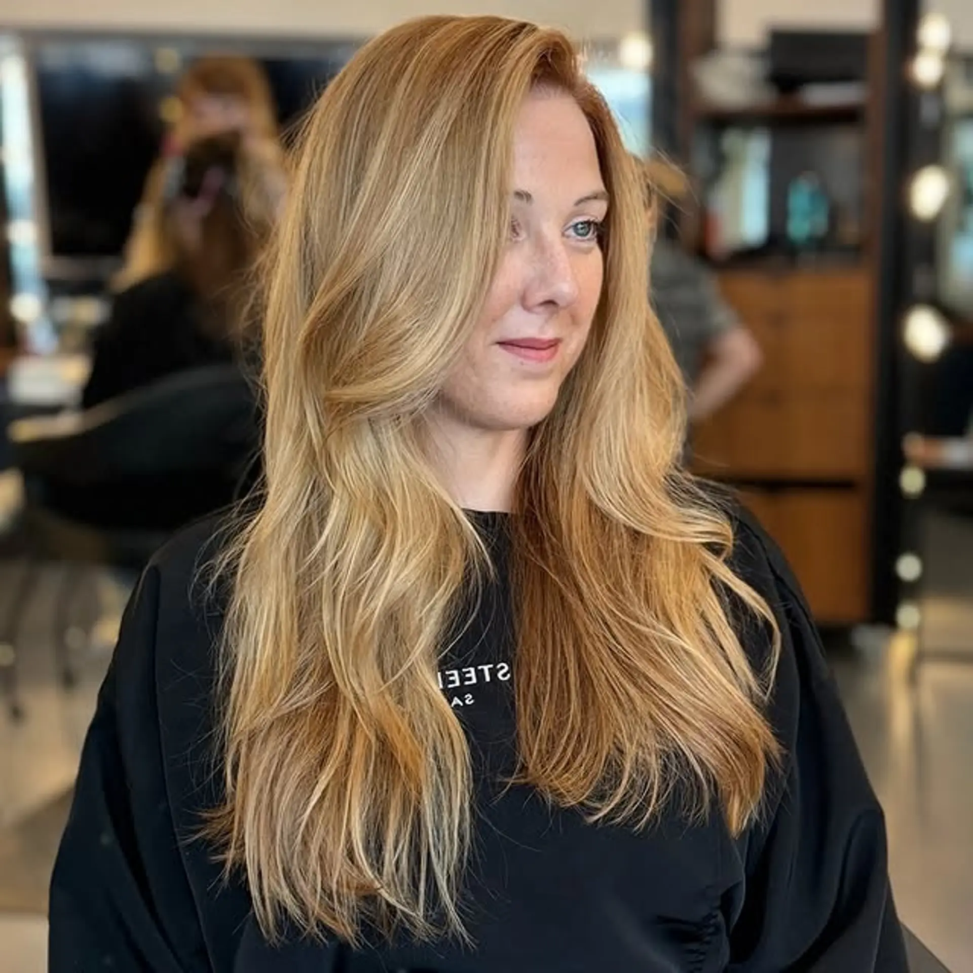 A long, layered hairstyle with face-framing layers. 1