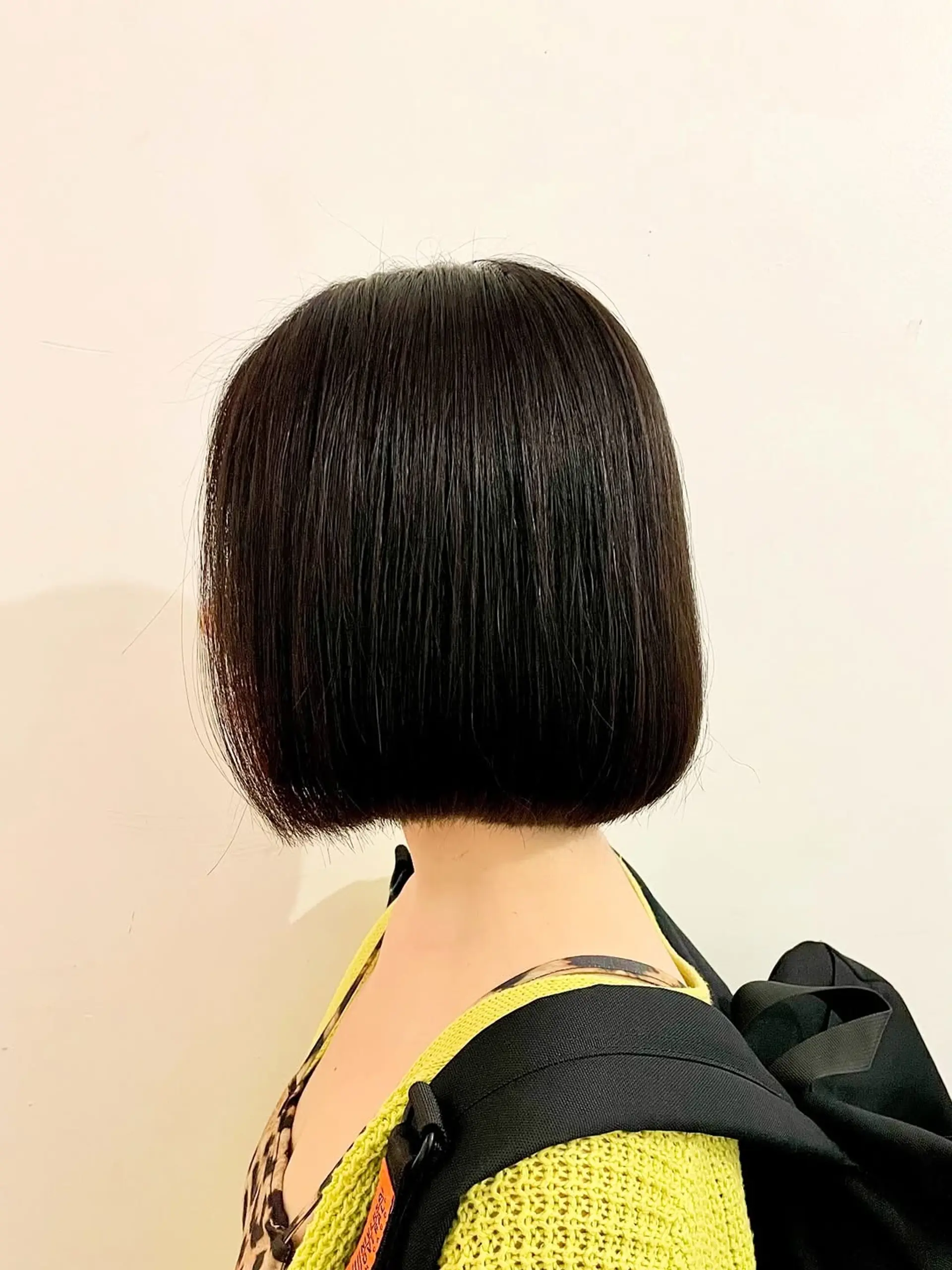 A sleek and sharp blunt bob, cut precisely at the nape, creating a modern and polished silhouette with straight edges and a smooth finish. 1
