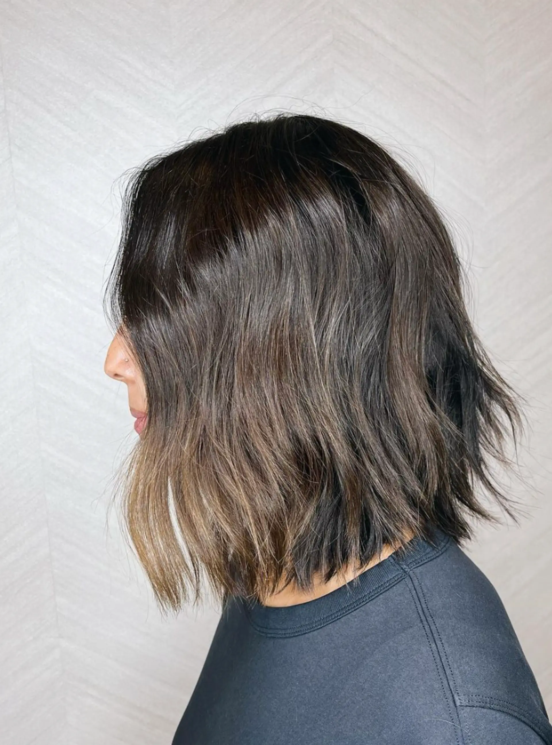 Medium-length chic wavy bob with dark brown hair and subtle highlights. Loose, natural waves with a side part and face-framing layers.

Cut and style by @juliamannino_hair
 2