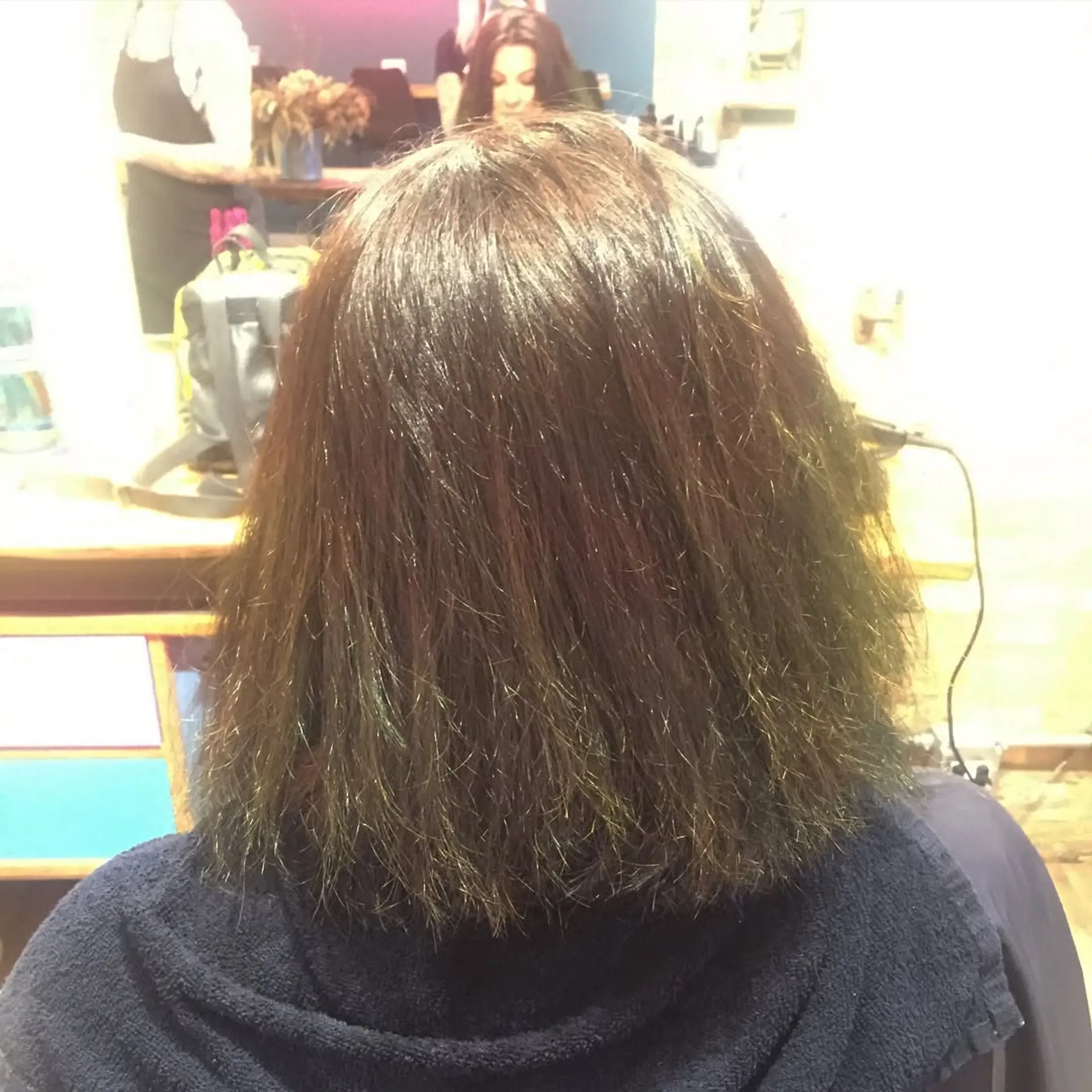 A striking ombre lob with a smooth transition from dark roots to vibrant teal ends. 2